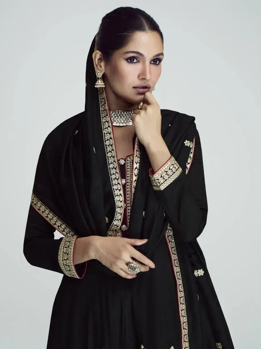 Black ethnic anarkali suit with gold embroidery, perfect for Indian weddings or festive occasions