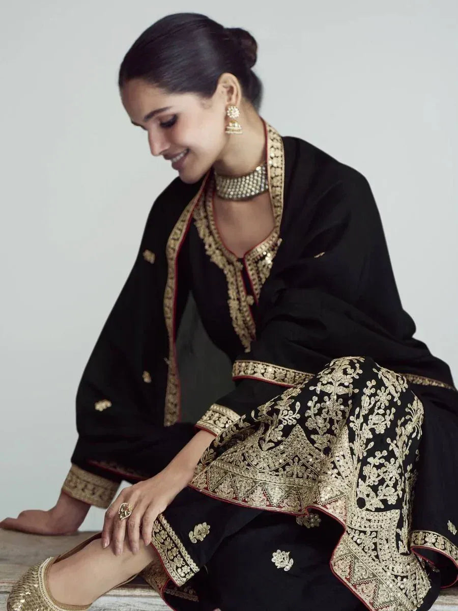 Black and gold embroidered salwar kameez with matching jewelry, elegant ethnic wear for women
