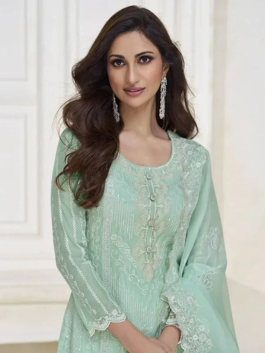 Mint green embroidered salwar kameez with lace detailing, perfect for Indian ethnic wear occasions.