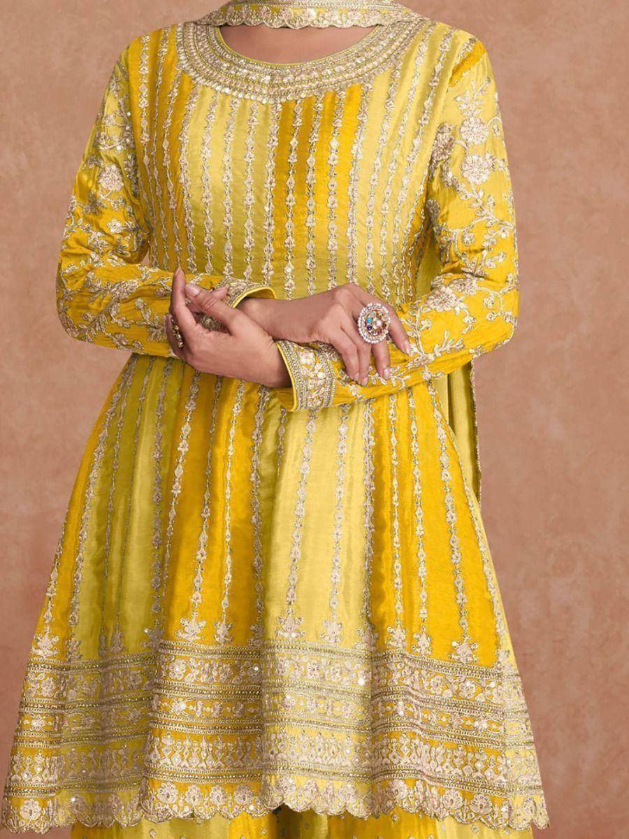 Yellow embroidered ethnic anarkali suit with gold detailing, perfect for Indian festive occasions