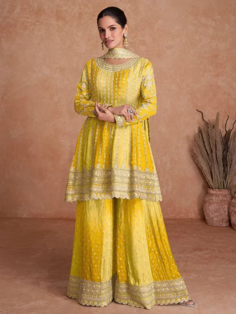 Yellow embroidered ethnic salwar kameez with gold detailing, perfect for festive occasions