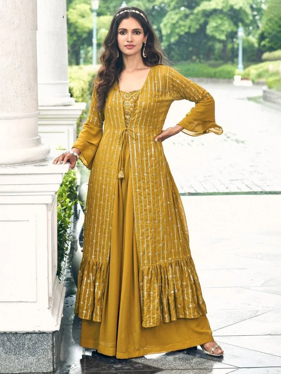 Woman in mustard yellow ethnic gown with flared sleeves and sequin detailing outdoors