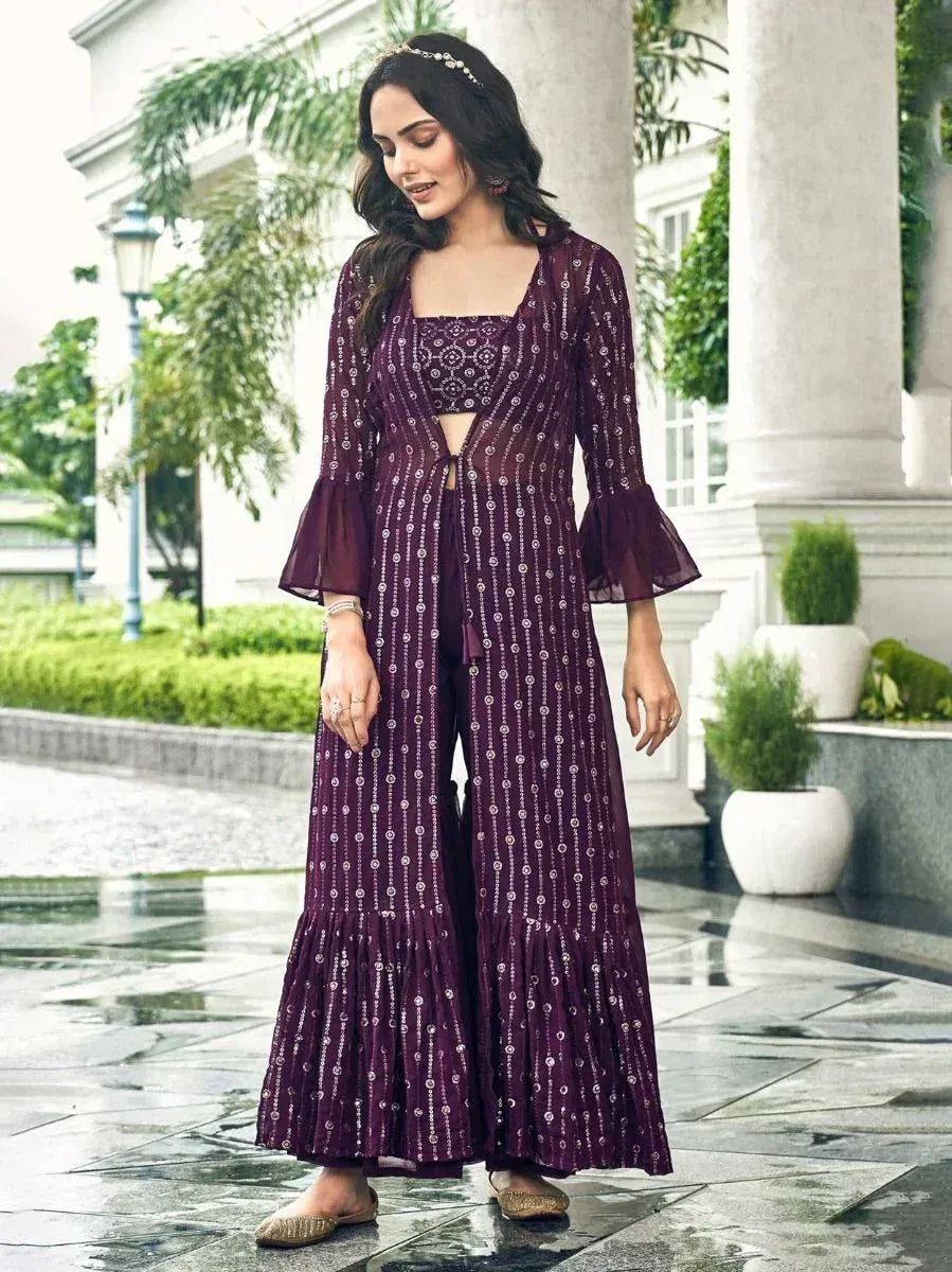 Woman in purple embroidered ethnic jacket and palazzo set with flared sleeves, outdoor setting