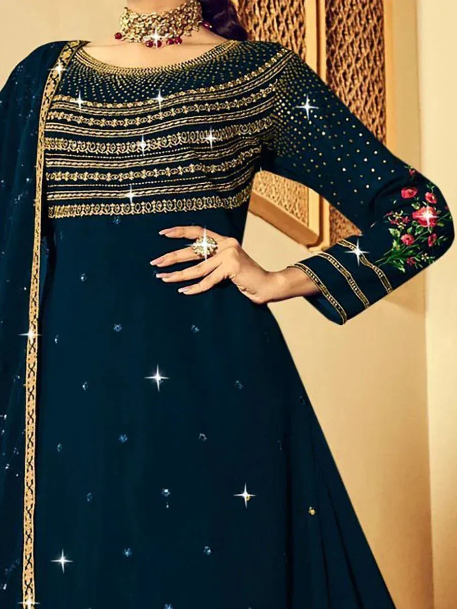 Dark blue ethnic gown with gold embroidery and floral sleeve design, perfect for Indian occasions