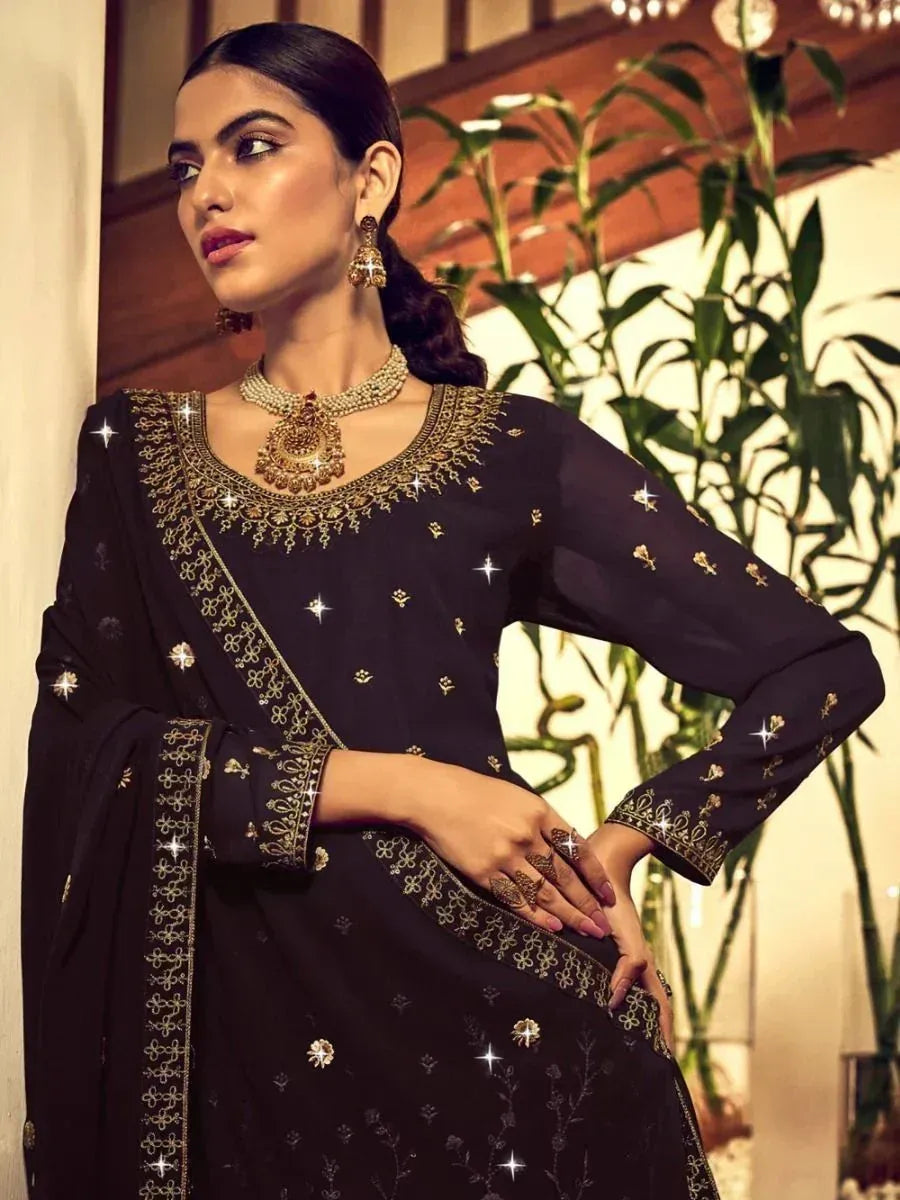 Black embroidered salwar kameez with gold detailing, perfect for ethnic occasions and festive wear.