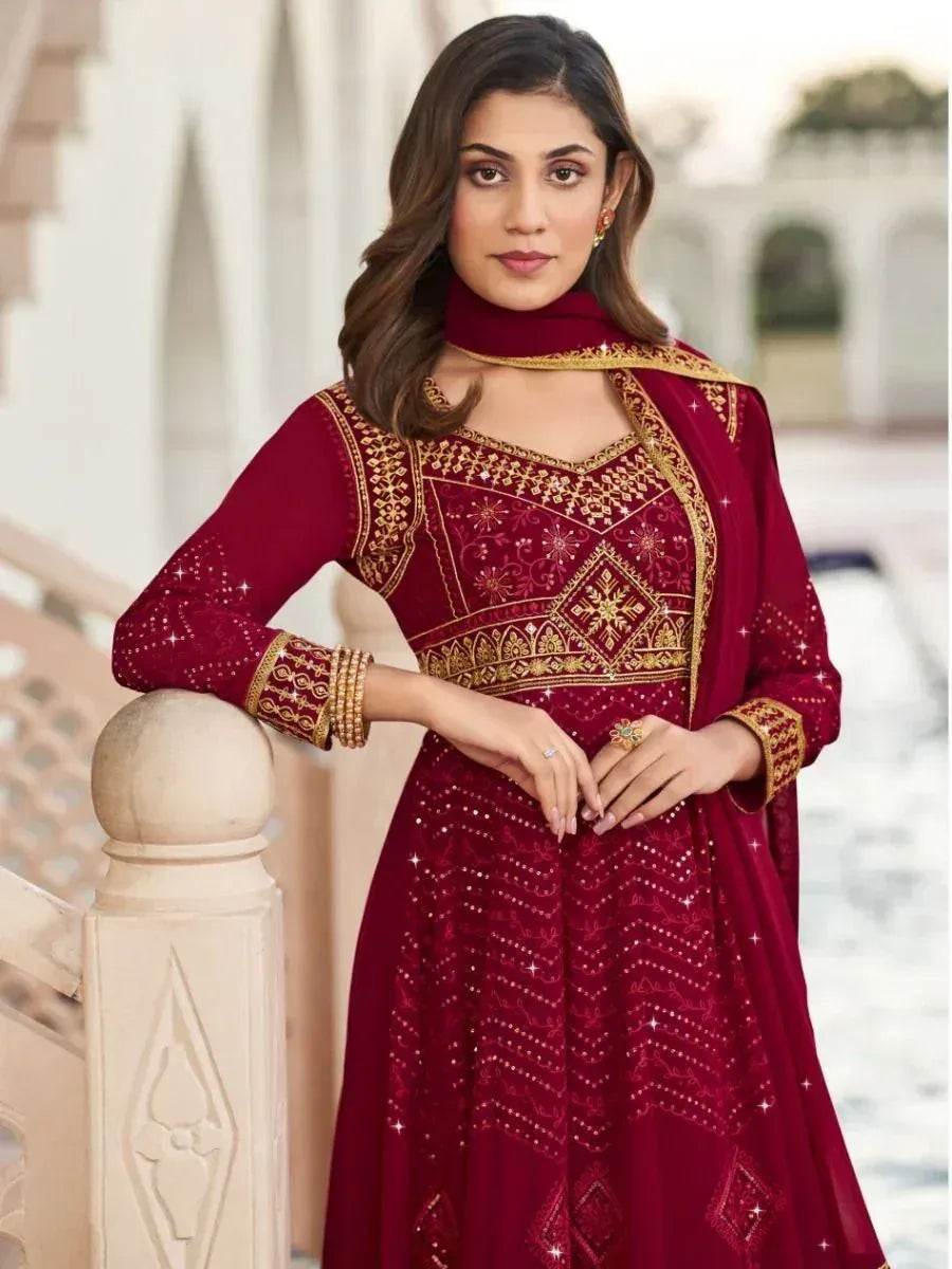 Maroon ethnic gown with gold embroidery, perfect for Indian weddings and festive occasions