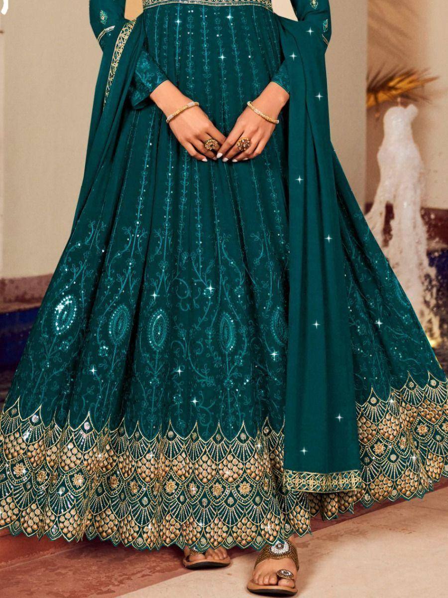 Emerald green designer anarkali with gold embroidery and sequin detailing, perfect for Indian ethnic occasions.