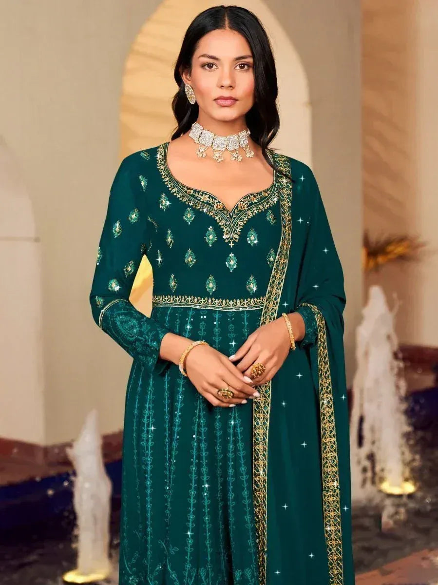 Emerald green embroidered ethnic gown with gold detailing, perfect for Indian festive occasions