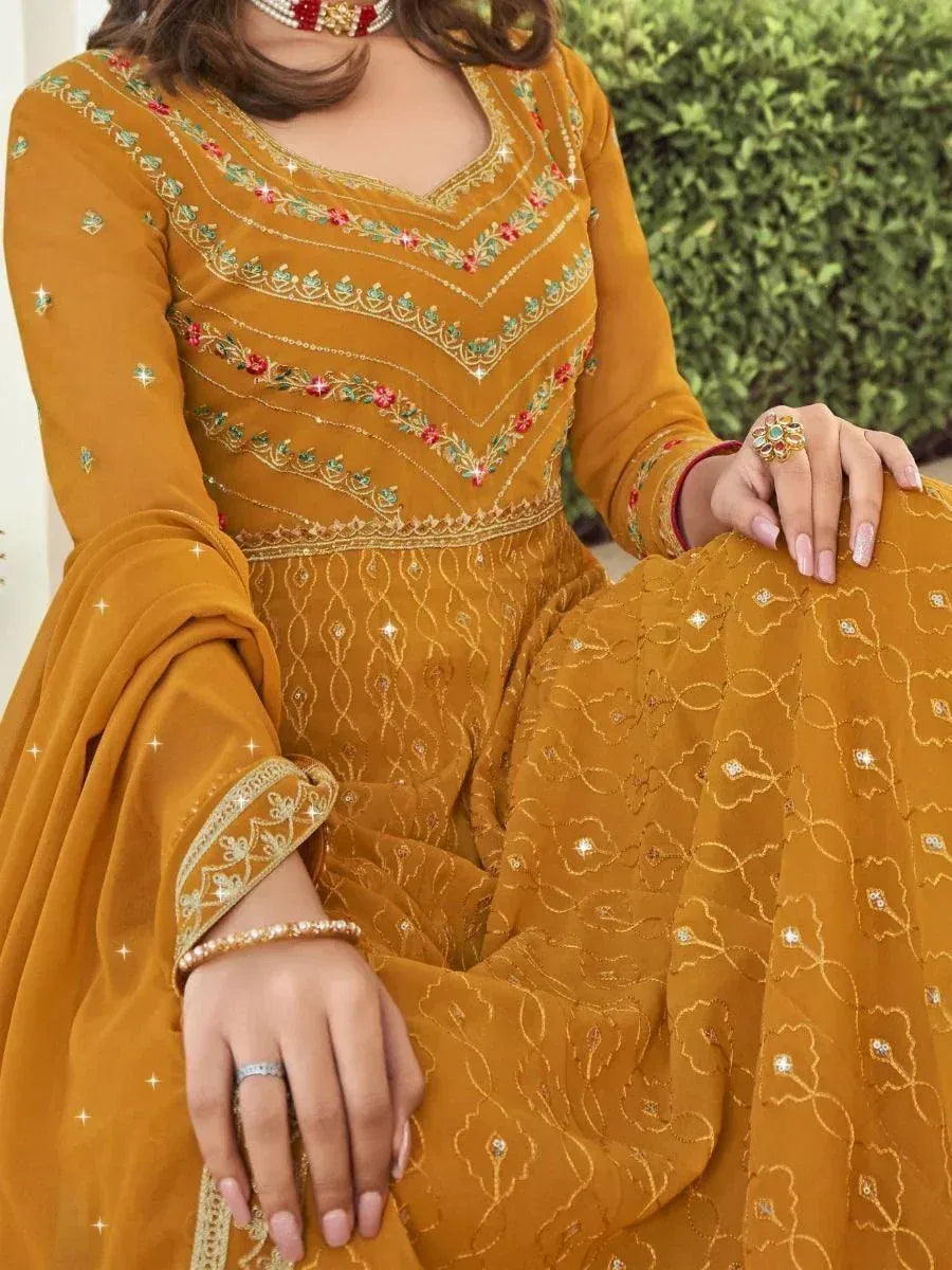 Mustard yellow embroidered salwar kameez with floral detailing and embellished neckline