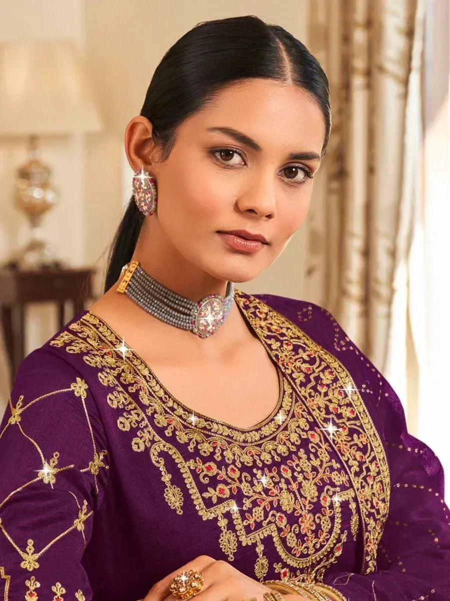 Purple embroidered ethnic kameez with gold detailing, paired with statement jewelry for festive occasions.