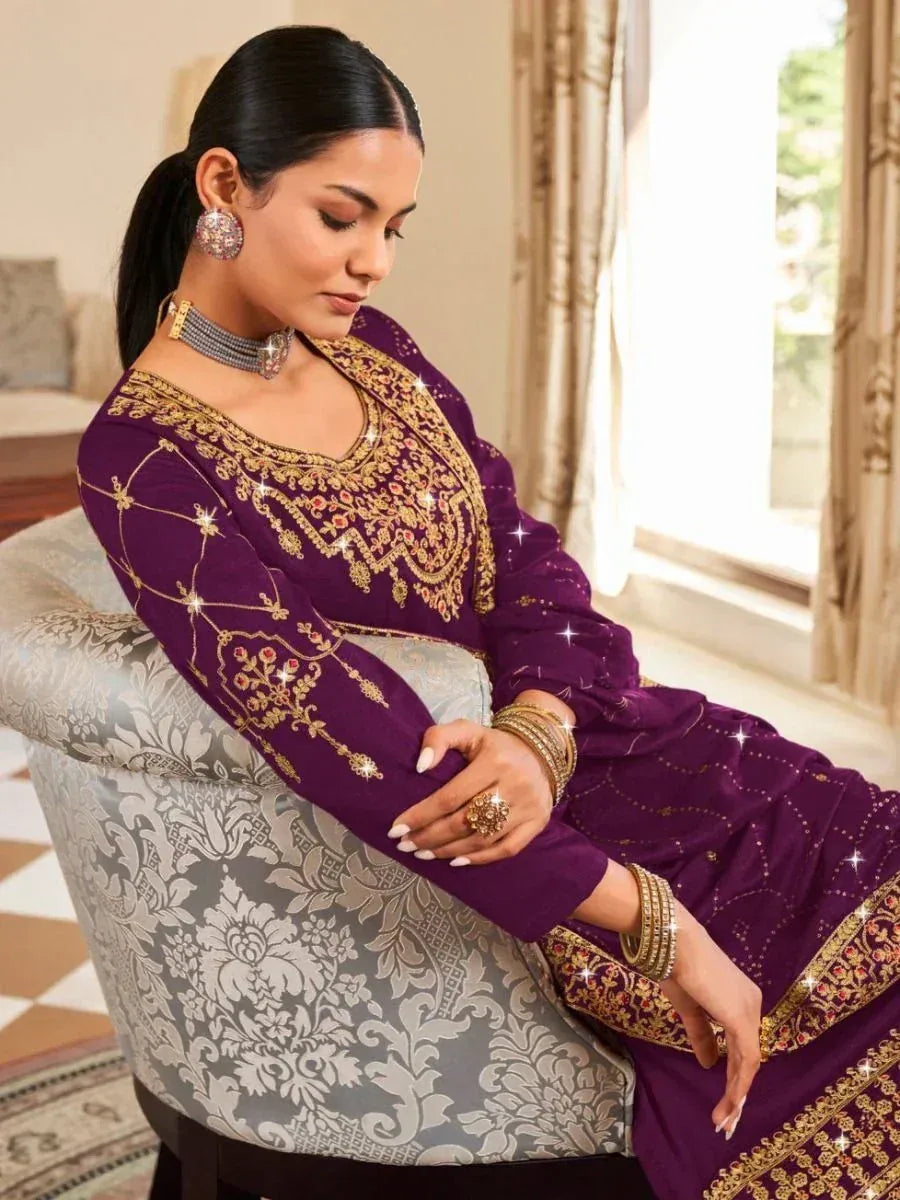 Purple embroidered ethnic gown with gold detailing, styled with choker and bangles for festive occasions