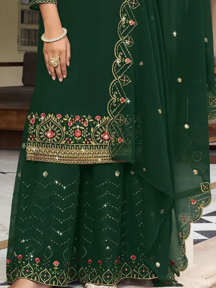 Green ethnic suit with gold embroidery and floral detailing, traditional Indian attire.