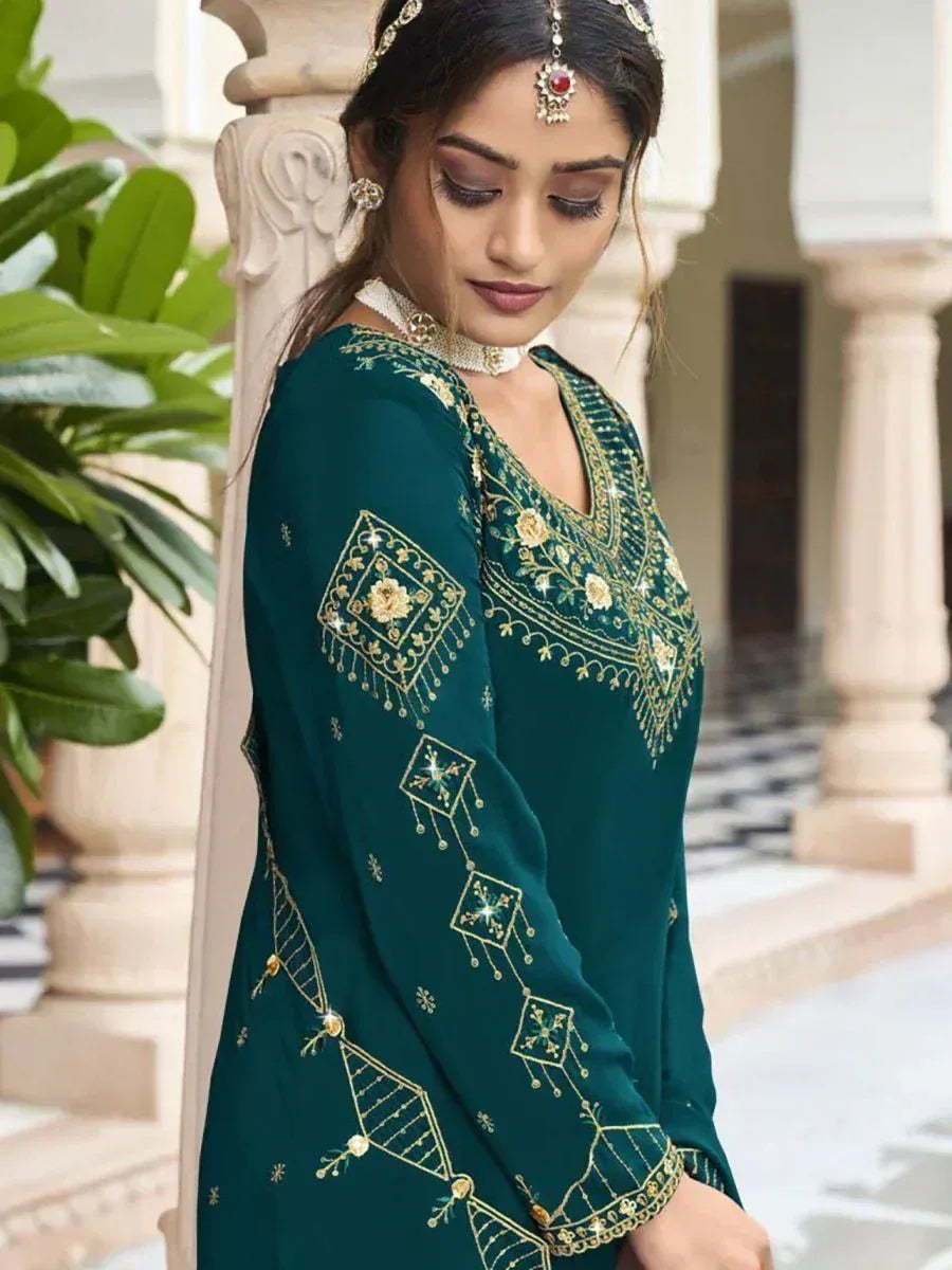 Woman in green designer salwar kameez with gold embroidery, traditional Indian ethnic wear