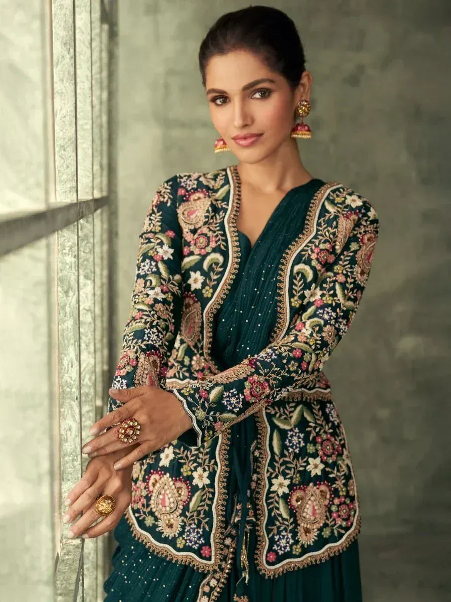 Elegant teal embroidered ethnic gown with floral motifs, perfect for Indian celebrations and weddings.