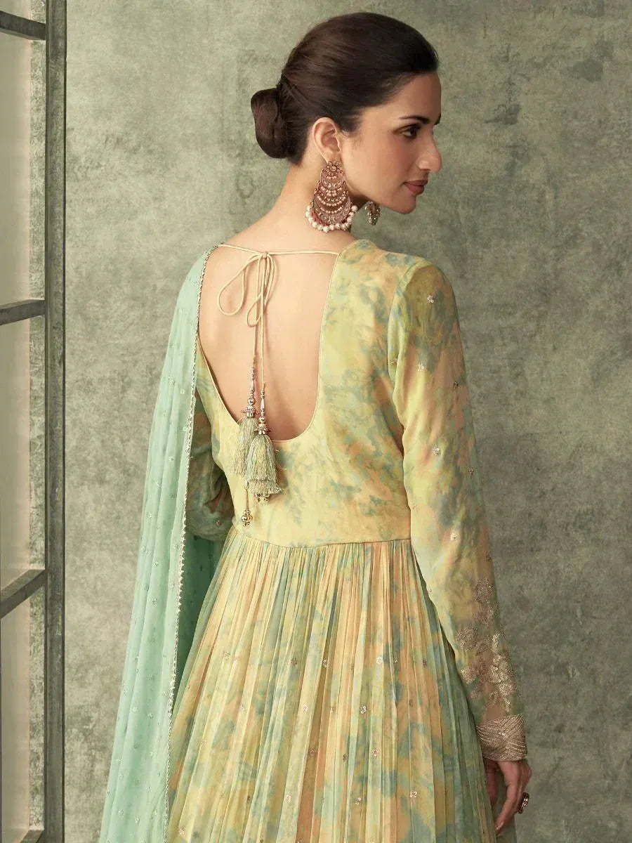 Elegant pastel green ethnic gown with back tie and tassels, perfect for Indian occasions