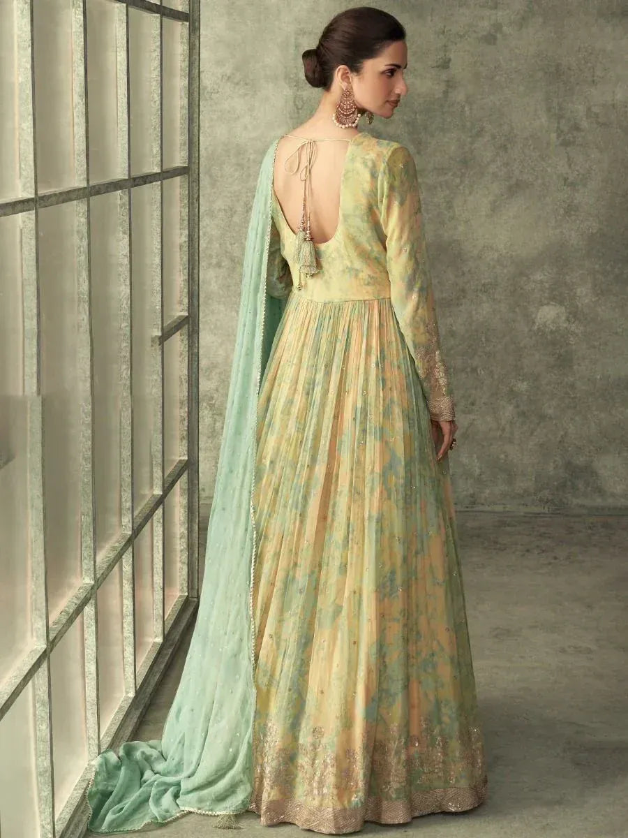 Elegant green and gold ethnic anarkali gown with back tie detail and matching dupatta, perfect for Indian weddings or festive occasions.