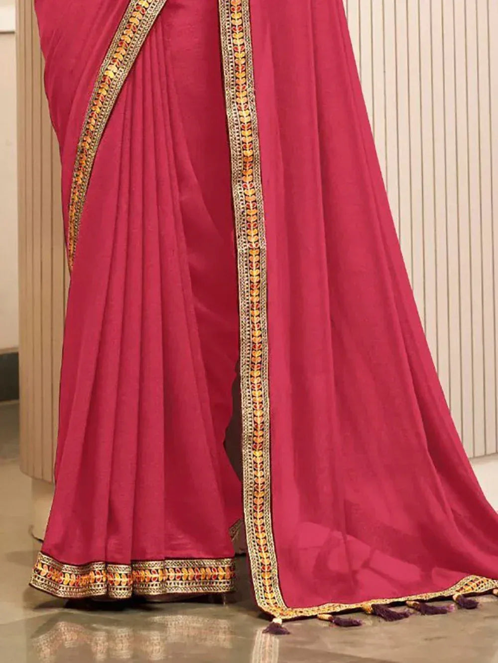 Pink saree with golden floral border and tassels, ethnic Indian wear