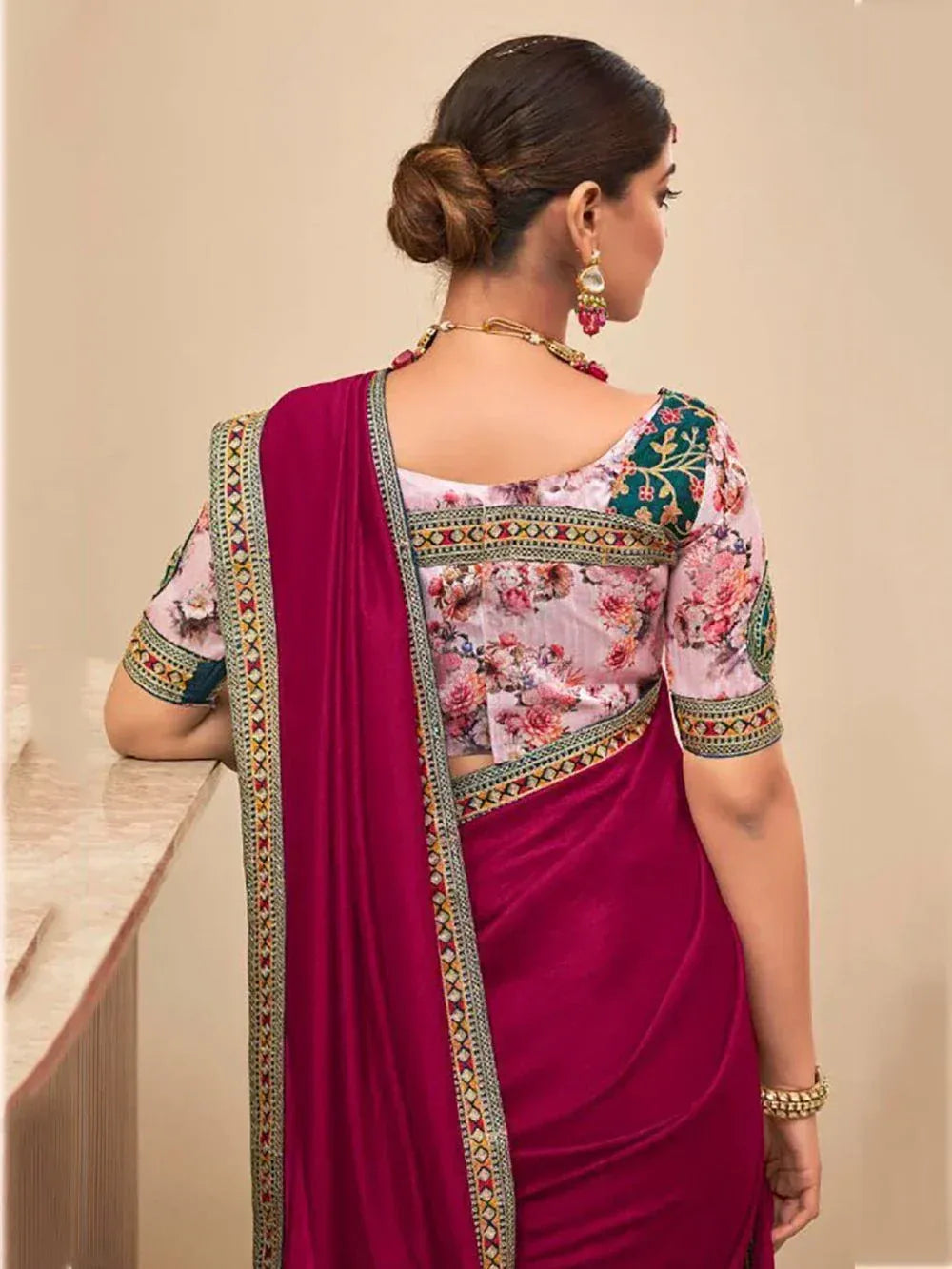 Woman in floral print blouse with magenta saree, ethnic Indian wear, back view