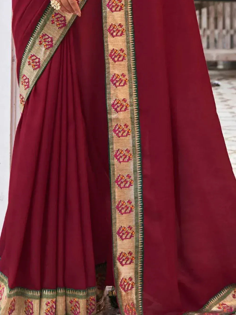 Maroon ethnic saree with floral border, perfect for Indian occasions and weddings
