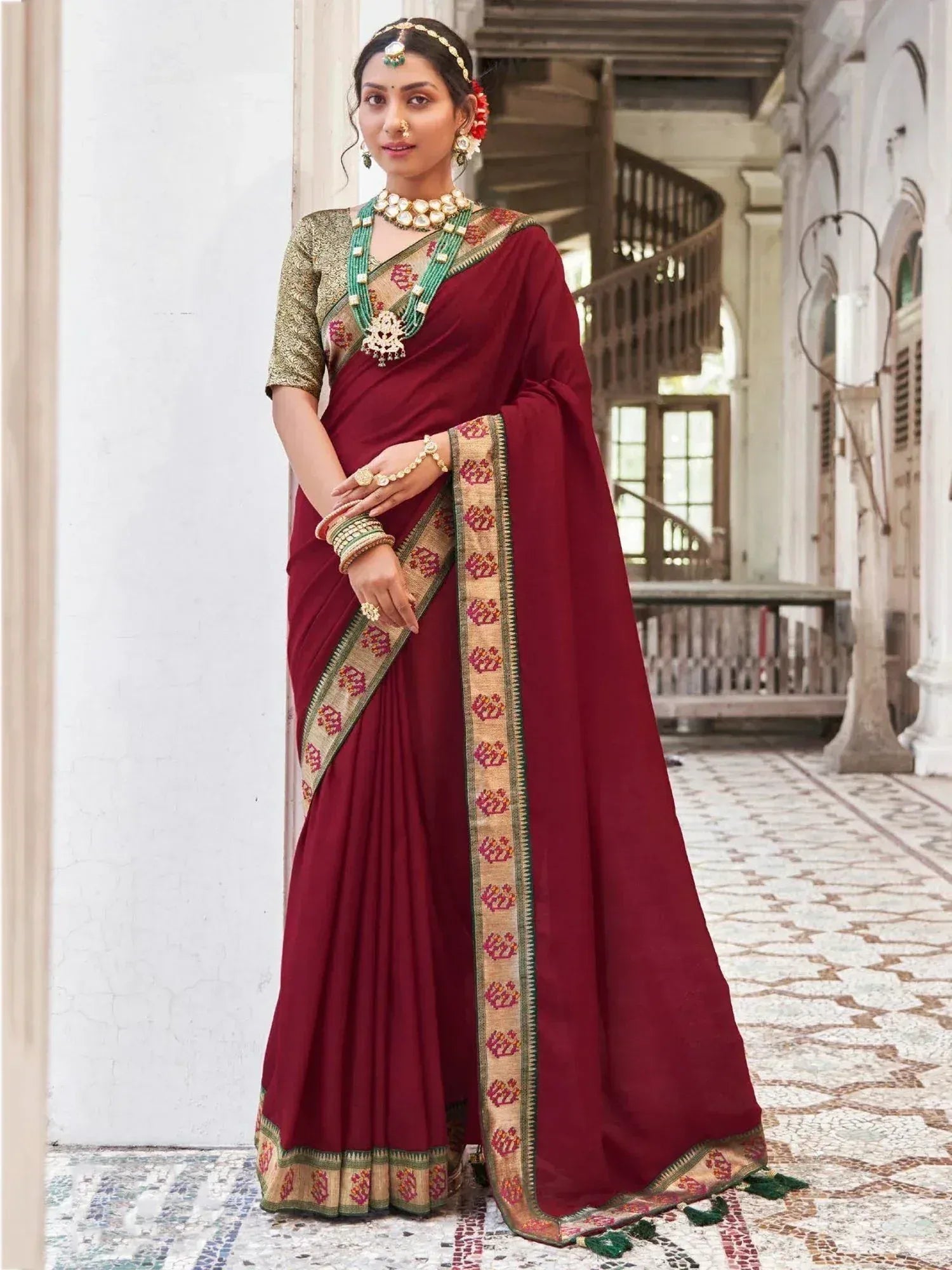 Maroon ethnic saree with gold and green border, perfect for Indian weddings and festive occasions