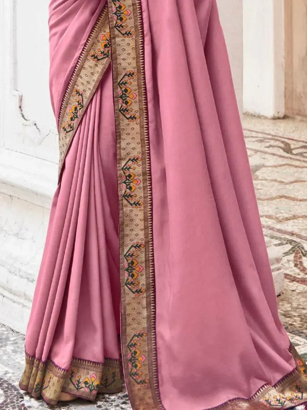 Pink ethnic saree with floral embroidered border, perfect for Indian occasions and festive wear