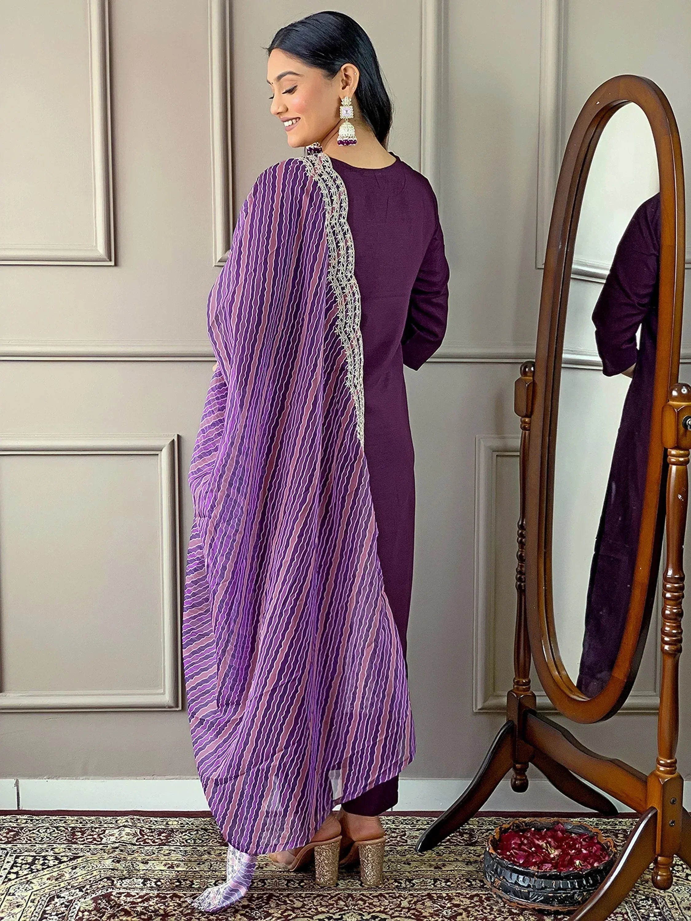 Woman in purple ethnic kurta with striped dupatta, traditional Indian wear for festive occasions