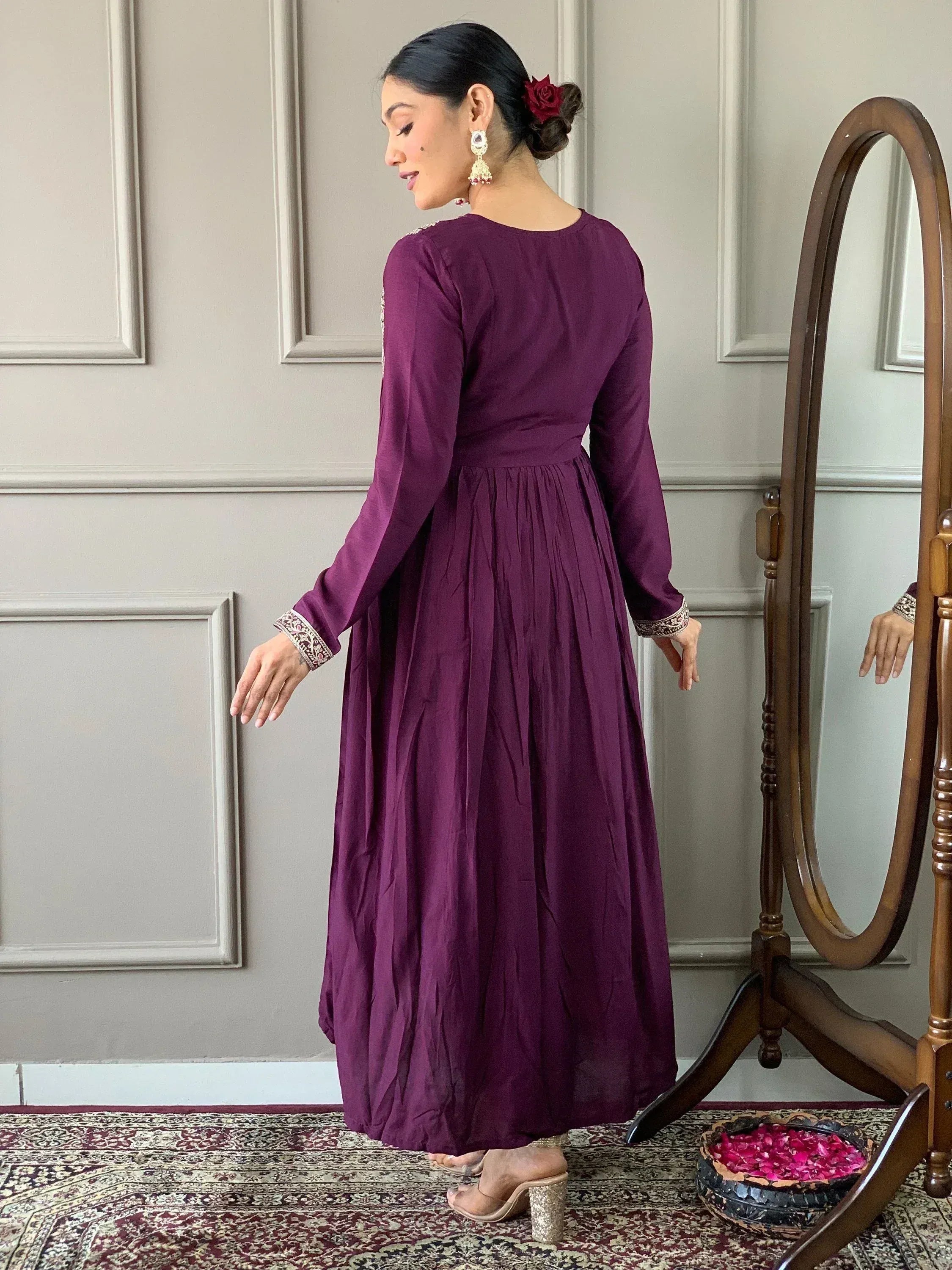Purple ethnic gown with embroidered sleeves, styled with jhumka earrings and rose hair accessory