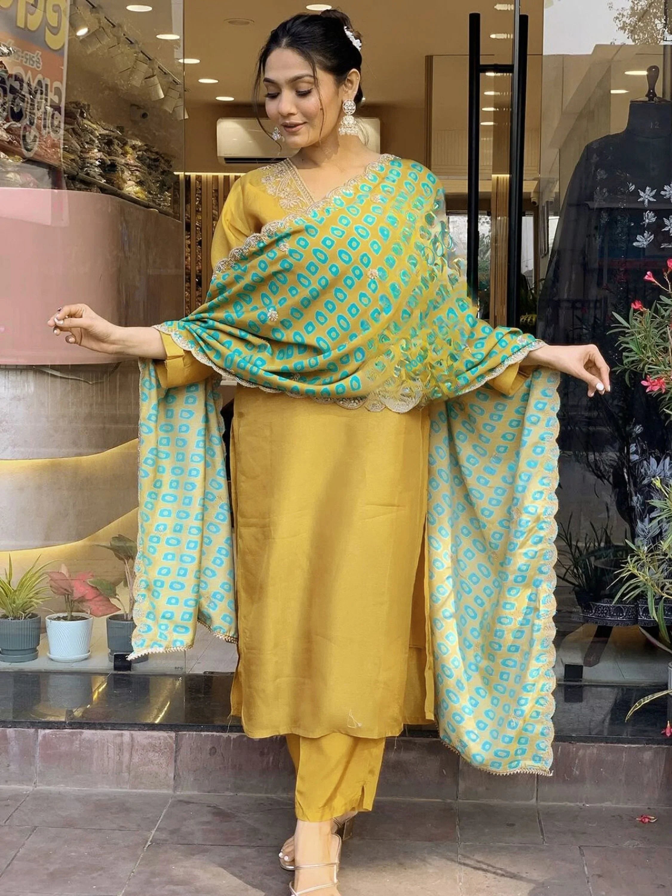 Woman wearing mustard yellow salwar kameez with blue printed dupatta, Indian ethnic outfit