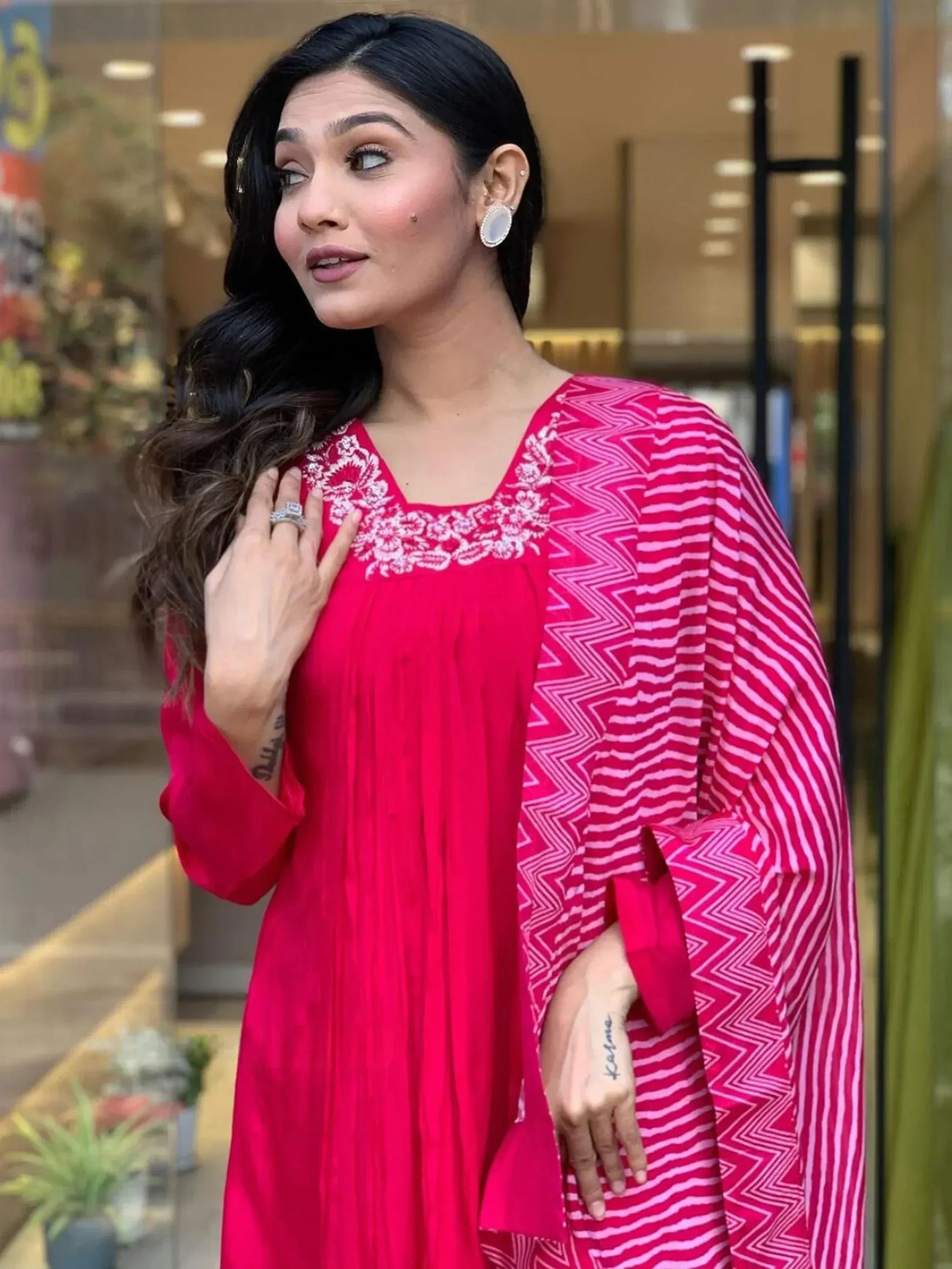 Vibrant pink ethnic kurta with white floral embroidery and geometric sleeve print, perfect for Indian festive wear.