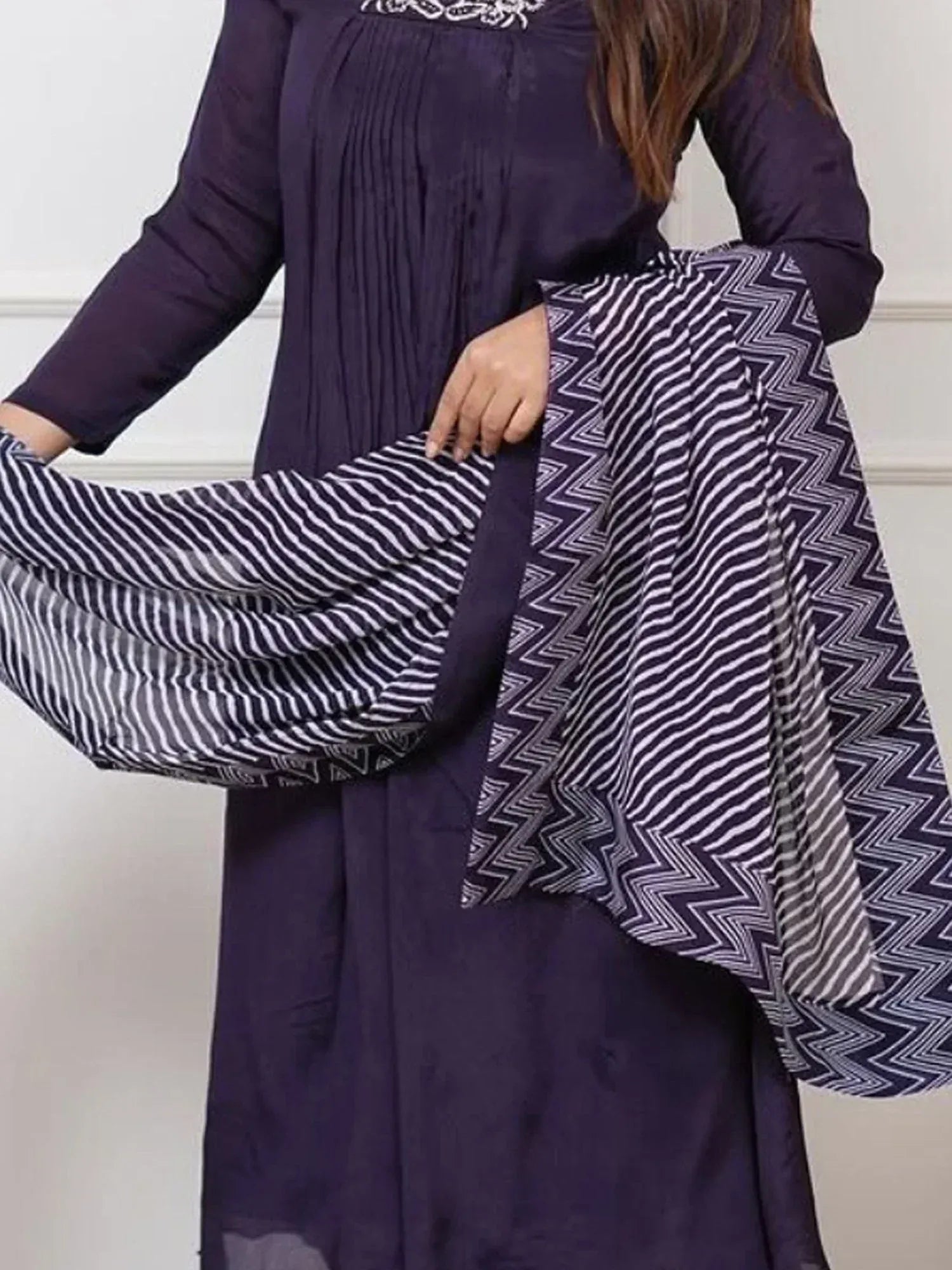 Purple ethnic kurta with pleated front, paired with zigzag patterned palazzo pants for traditional Indian wear