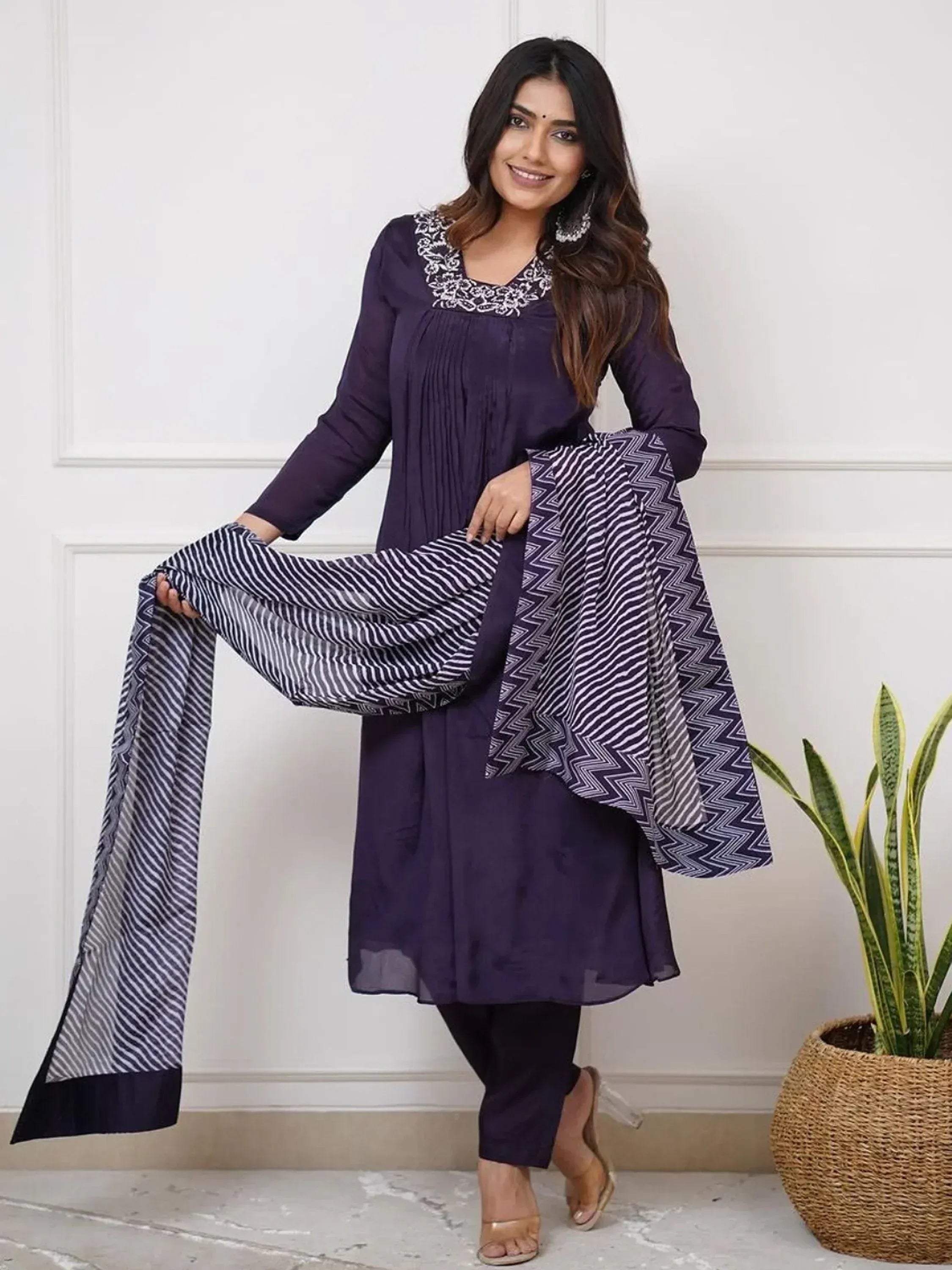 Purple ethnic kurti with white embroidery and patterned dupatta, paired with matching pants