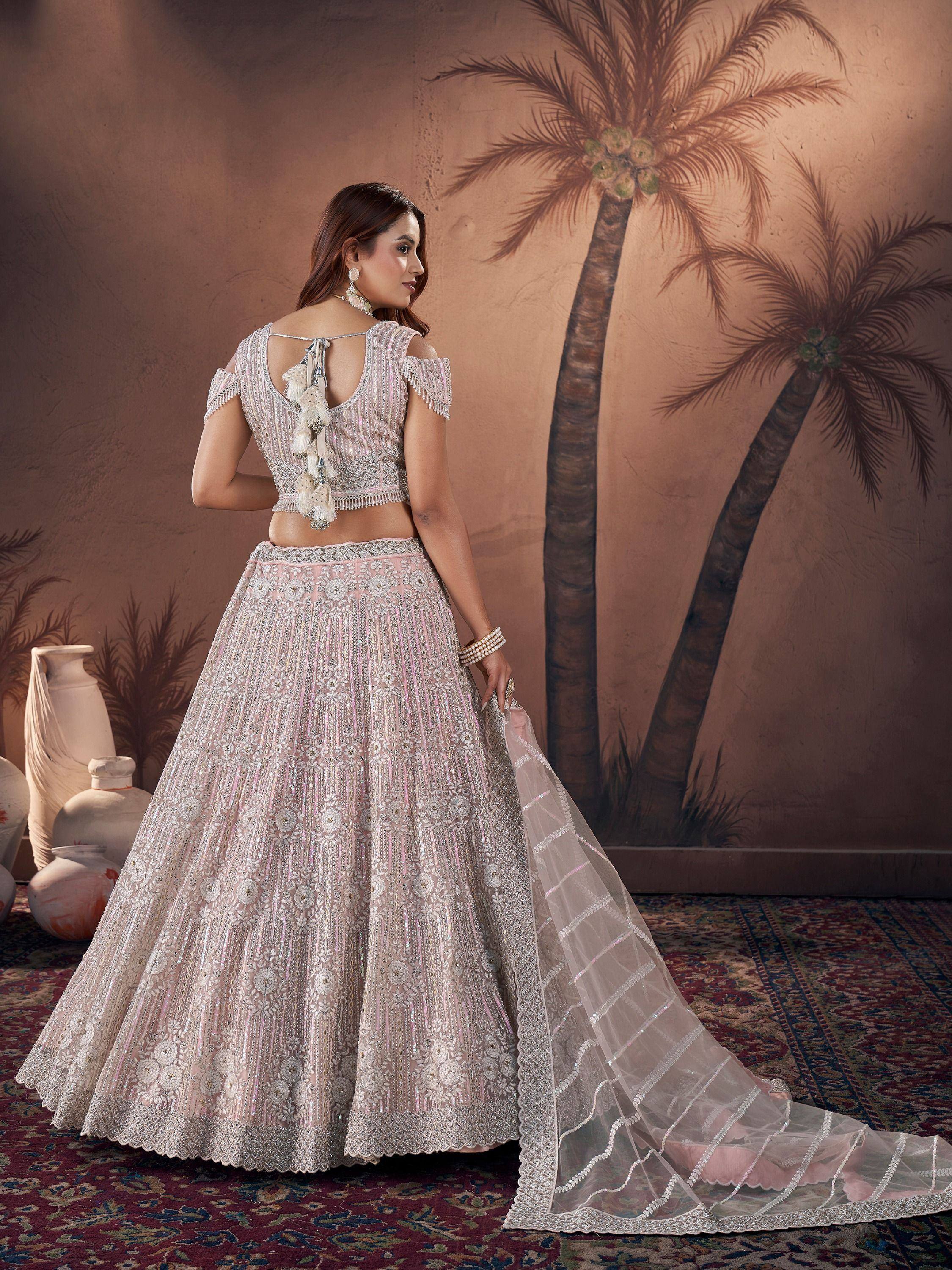 Elegant pink and silver embroidered lehenga choli with tassel back, perfect for Indian weddings and festive occasions.