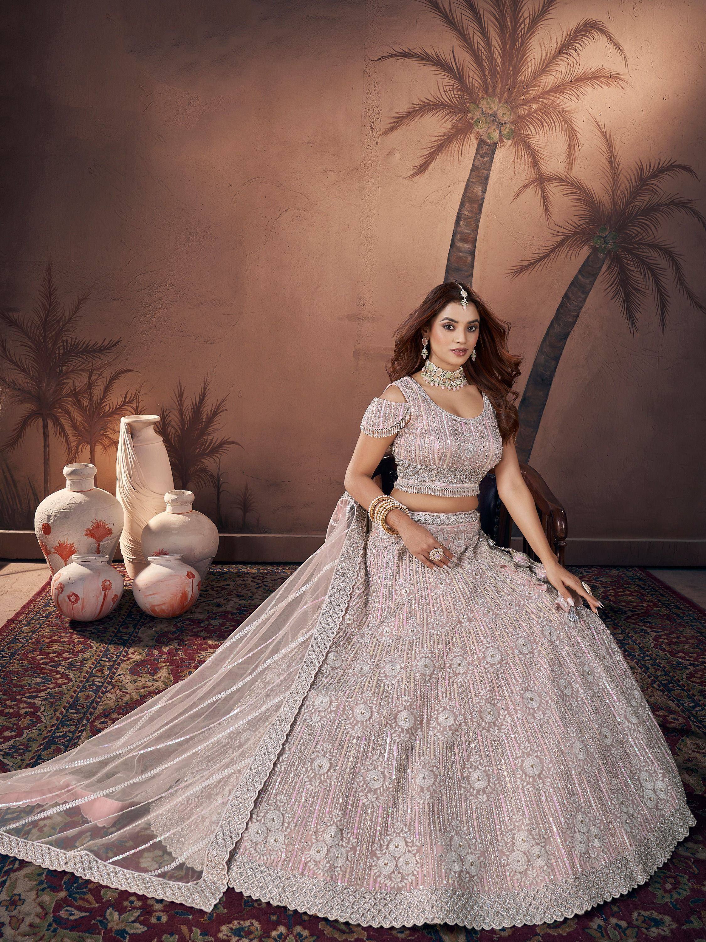 Elegant pink embroidered lehenga choli with off-shoulder blouse, perfect for weddings and festive occasions.