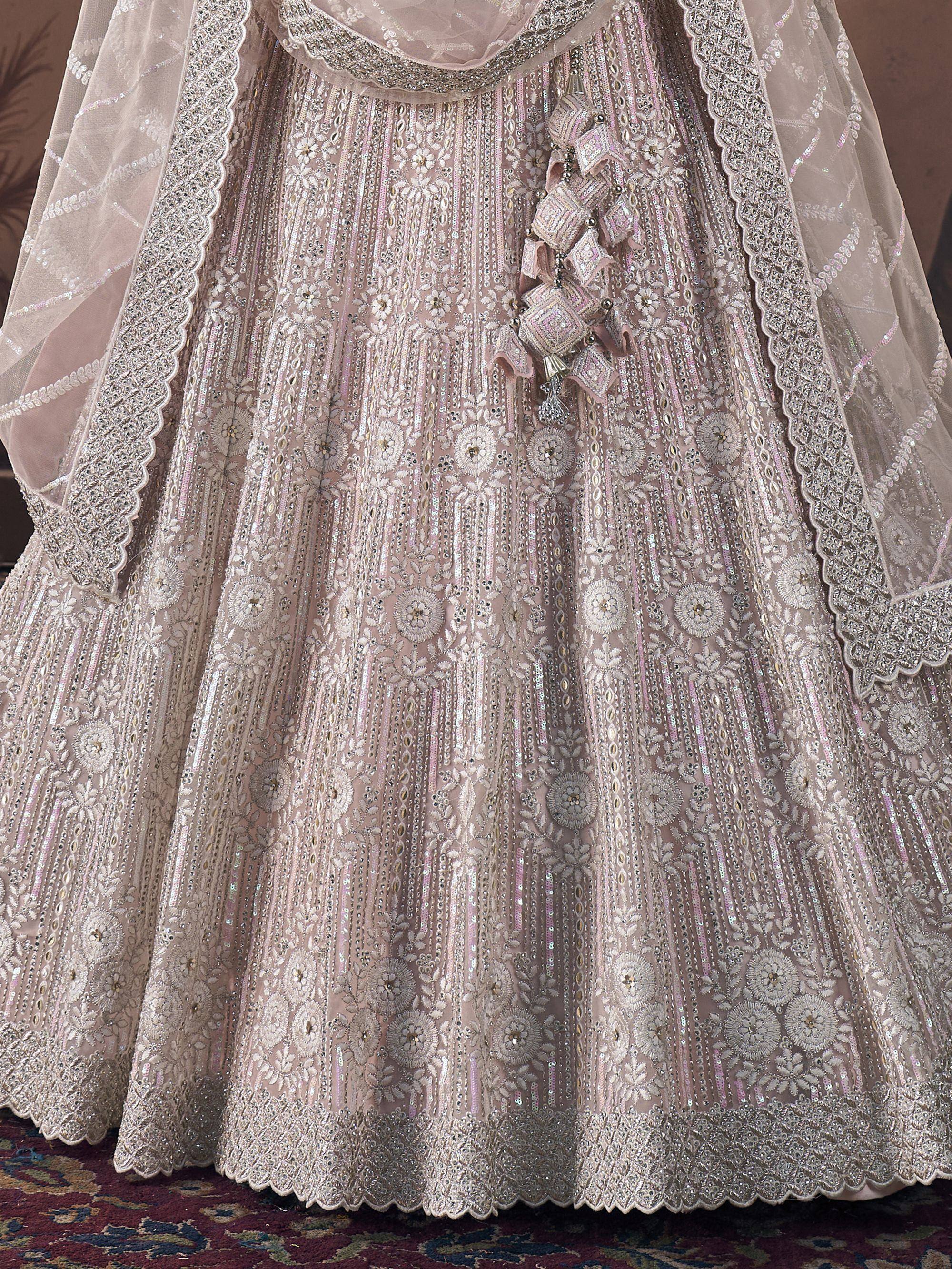 Elegant blush pink lehenga choli with intricate silver embroidery and sequin work, perfect for Indian weddings.