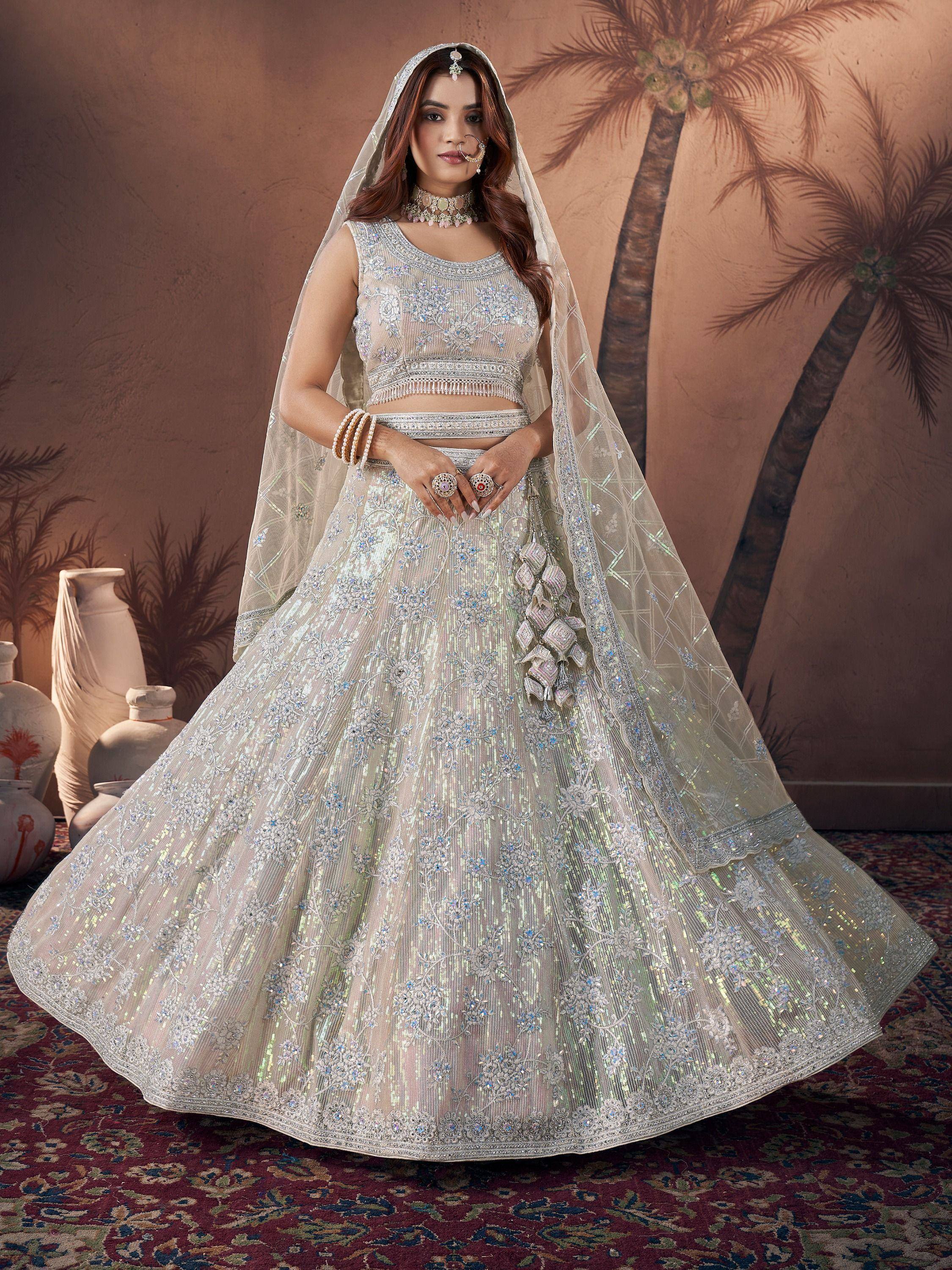 Elegant white bridal lehenga choli with intricate embroidery and dupatta, perfect for Indian weddings.
