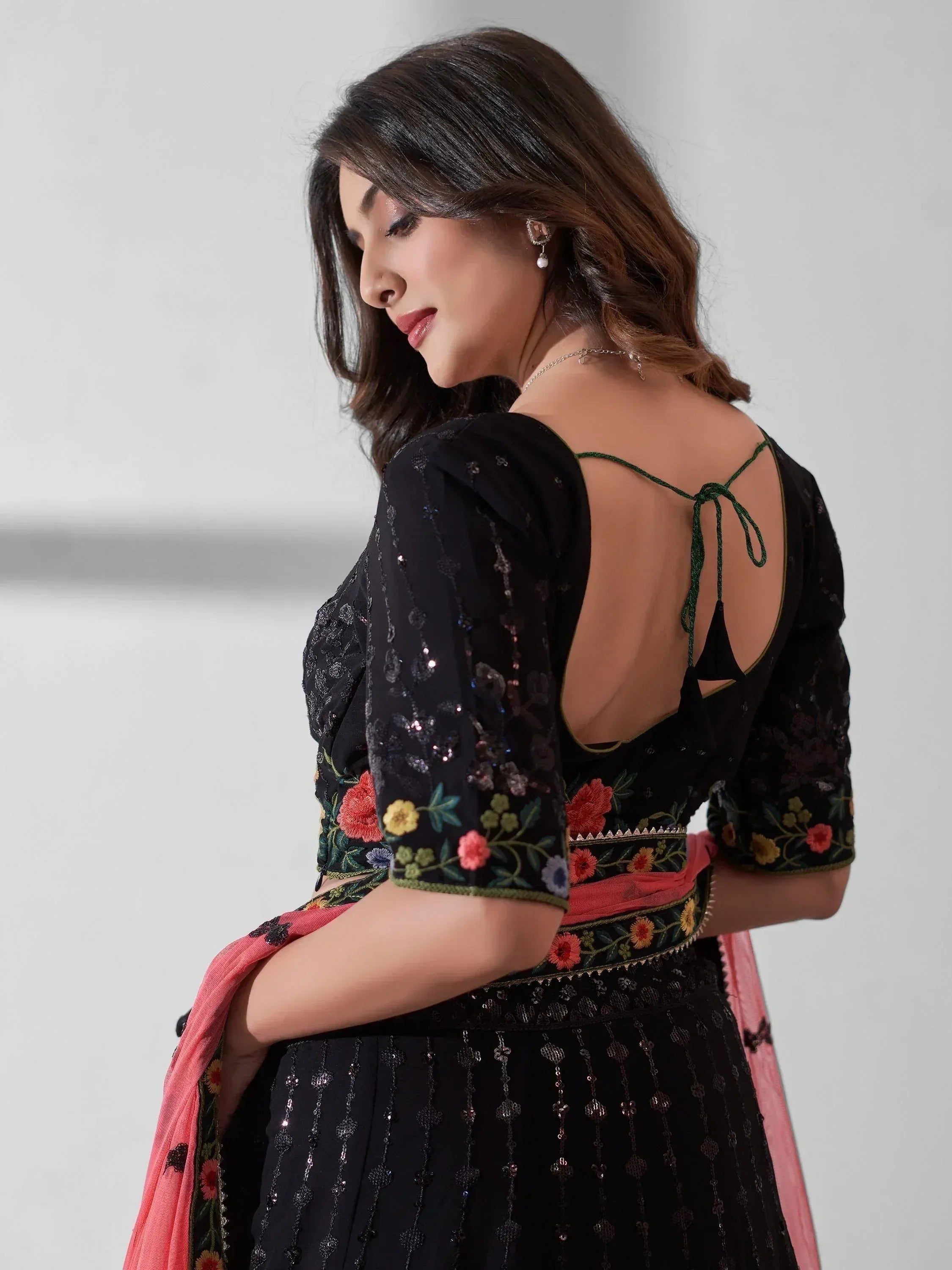 Black floral embroidered ethnic gown with open back and pink dupatta, perfect for Indian occasions