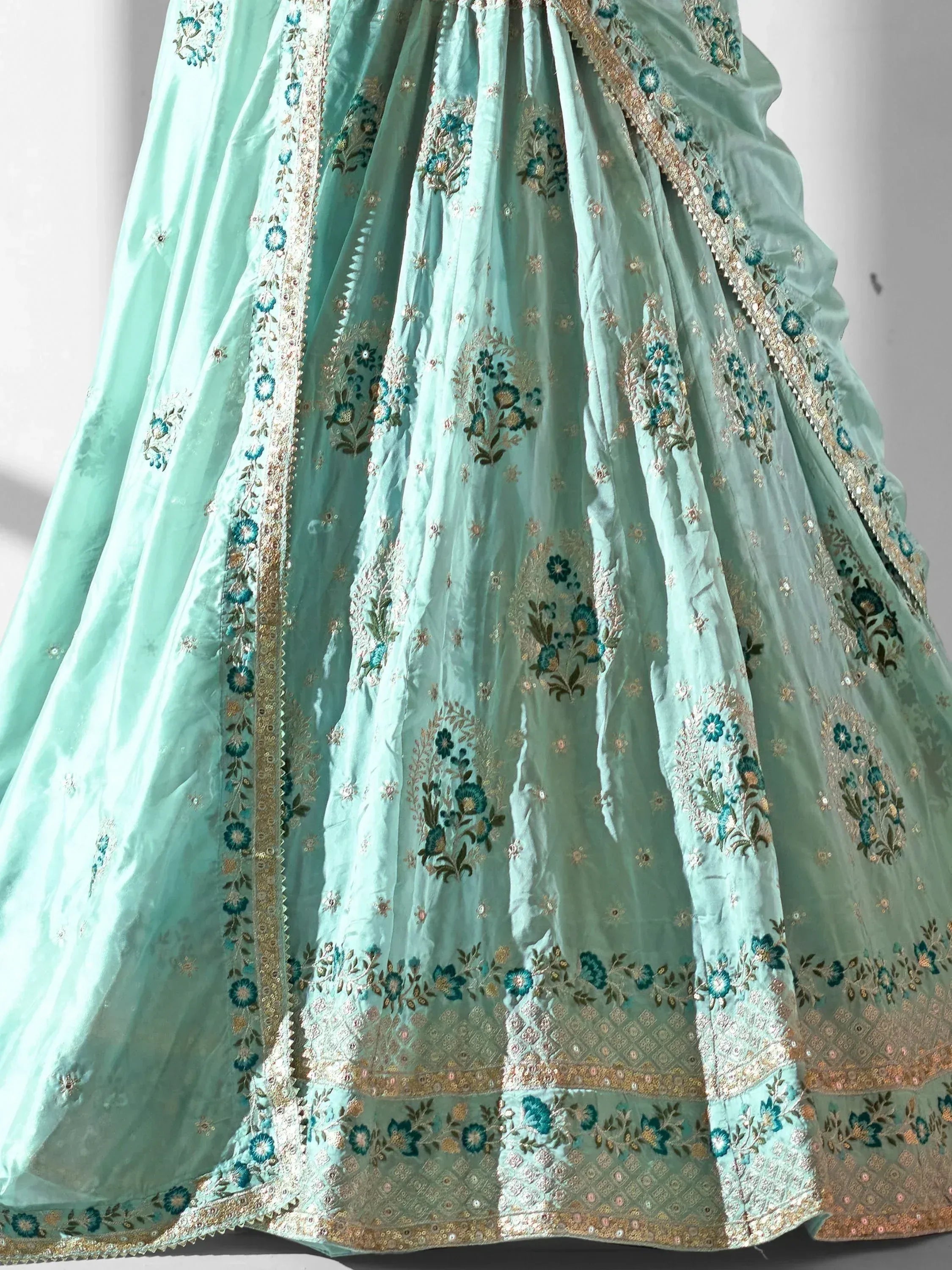 Mint green designer lehenga with floral embroidery and gold detailing for Indian ethnic wear