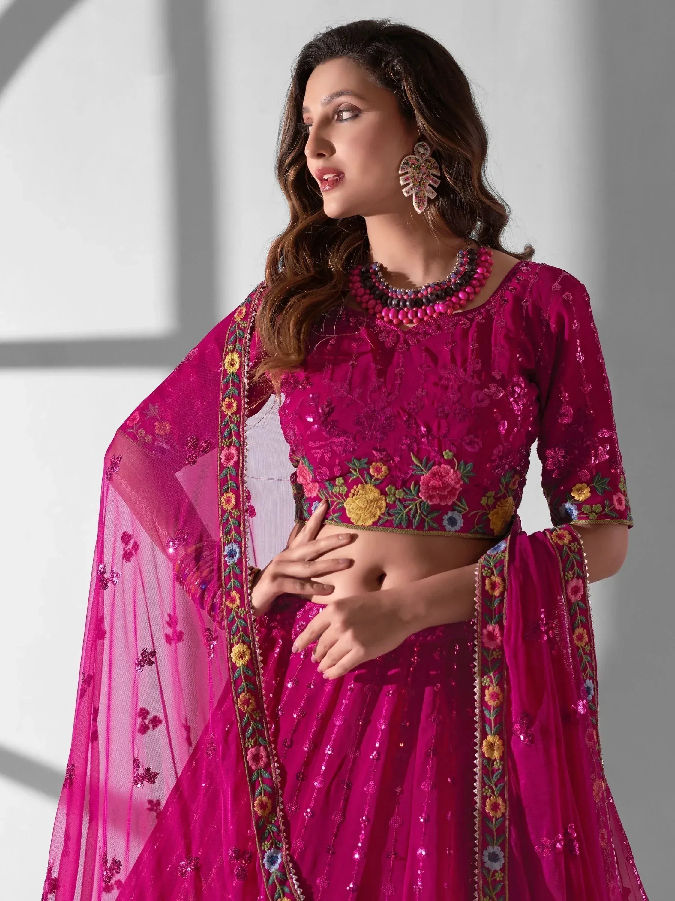 Fuchsia embroidered lehenga choli with floral dupatta, perfect for Indian ethnic occasions