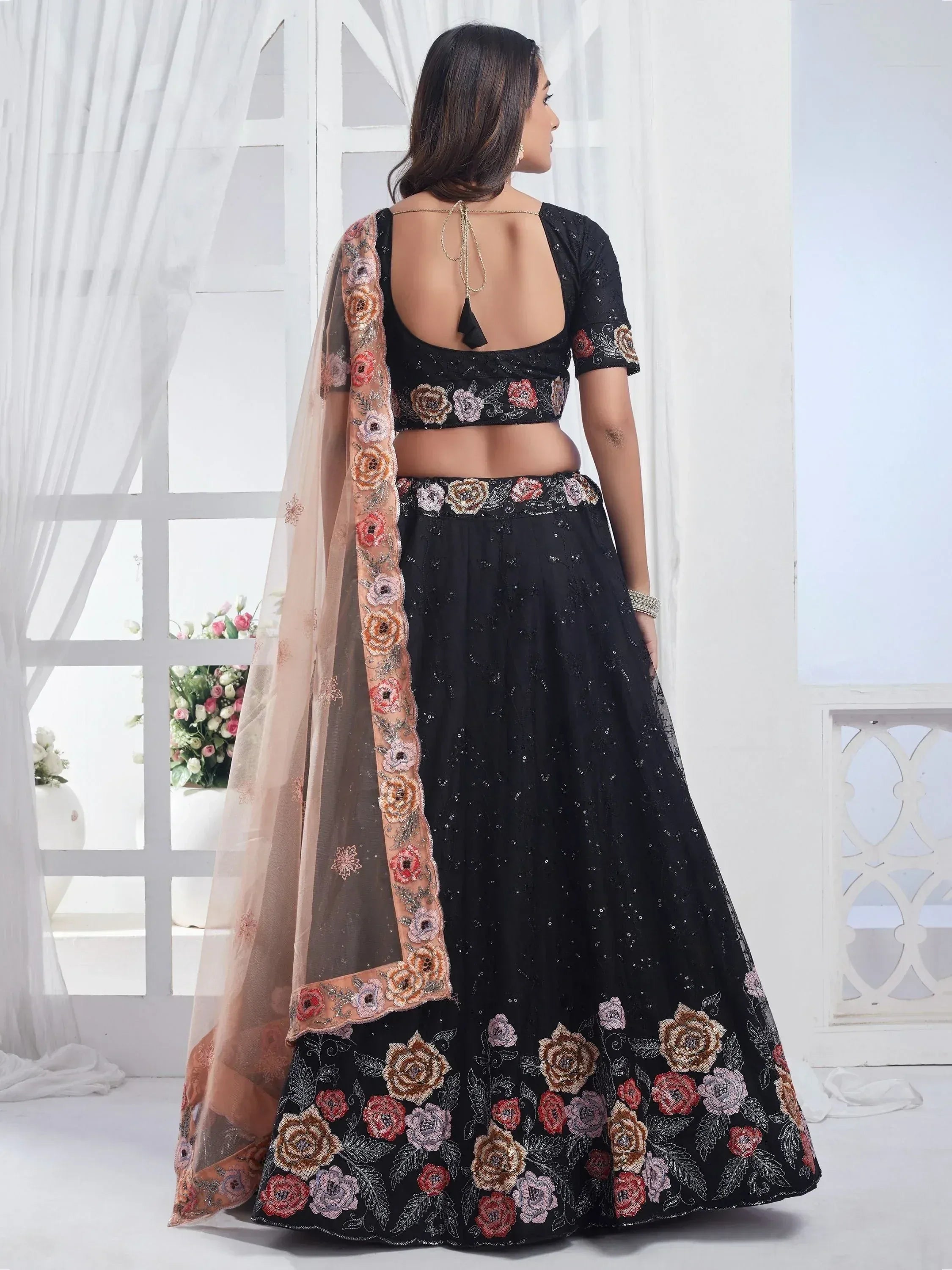 Black floral embroidered lehenga choli with sheer dupatta, back view, ethnic Indian wear
