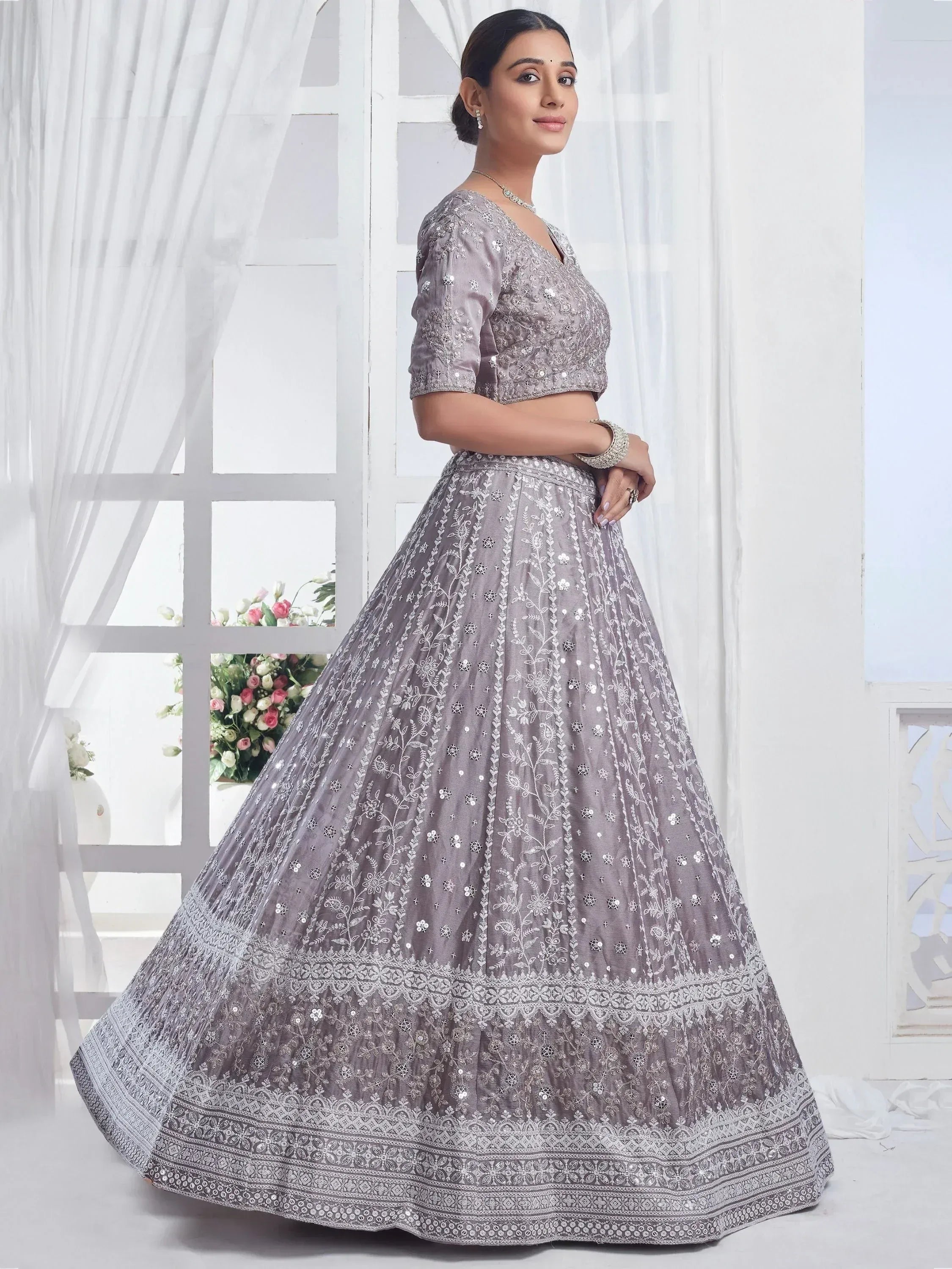 Grey embroidered lehenga choli with floral motifs and mirror work, perfect for Indian ethnic wear occasions.