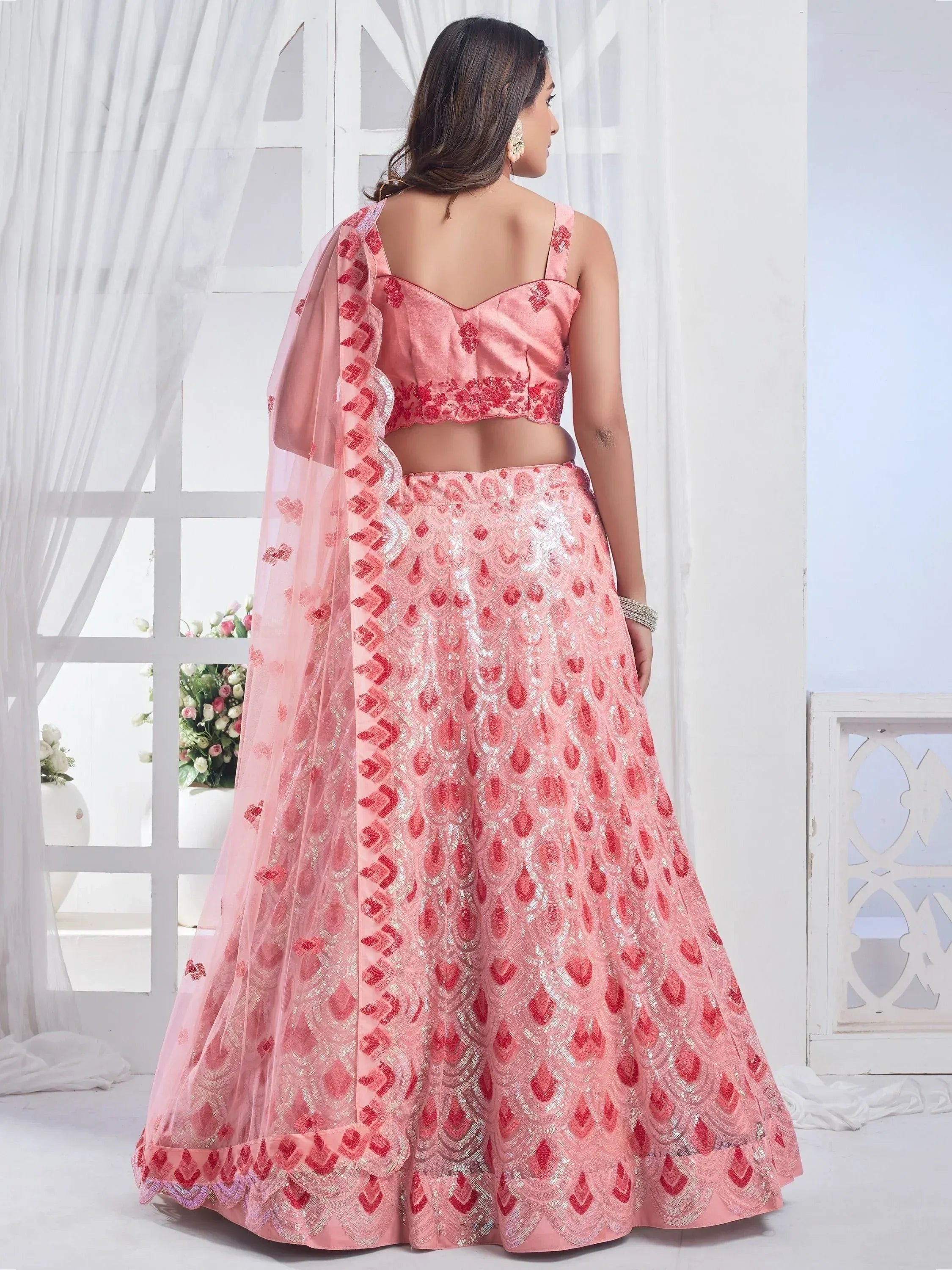 Pink designer lehenga choli with red embroidery and sequin work, perfect for Indian ethnic occasions