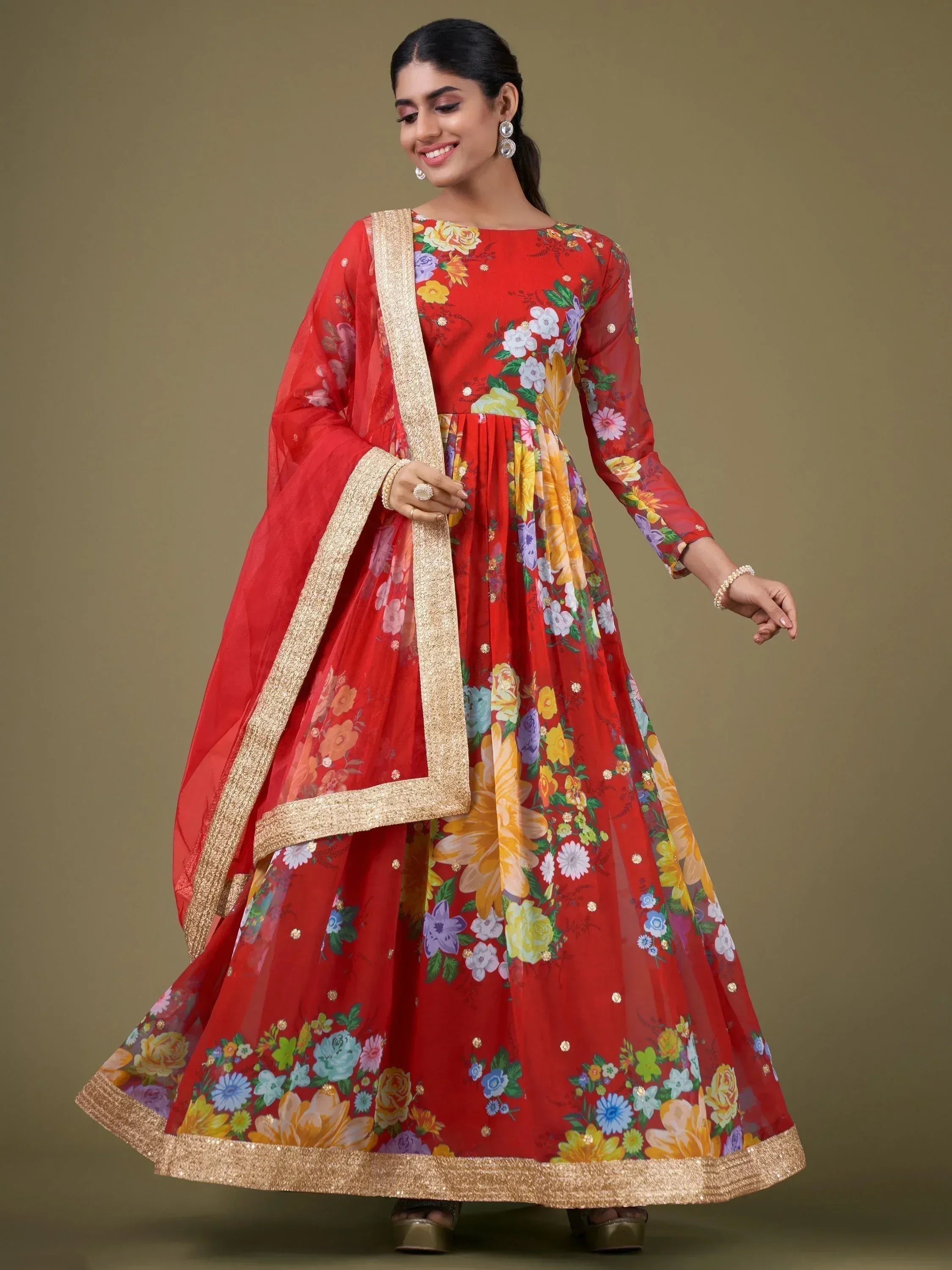 Red floral print ethnic anarkali suit with gold trim, perfect for Indian celebrations and weddings