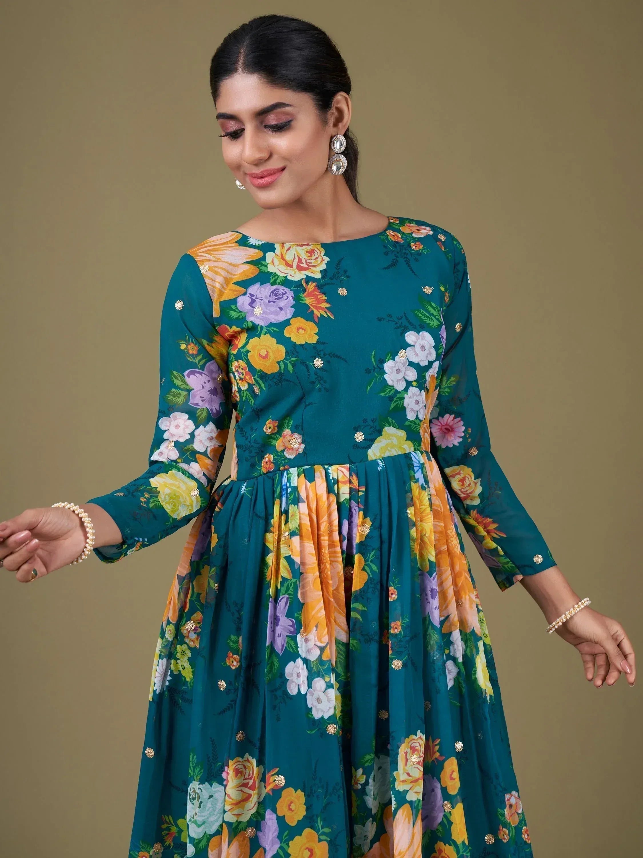 Teal floral print ethnic gown with long sleeves and gold accents, perfect for Indian occasions.