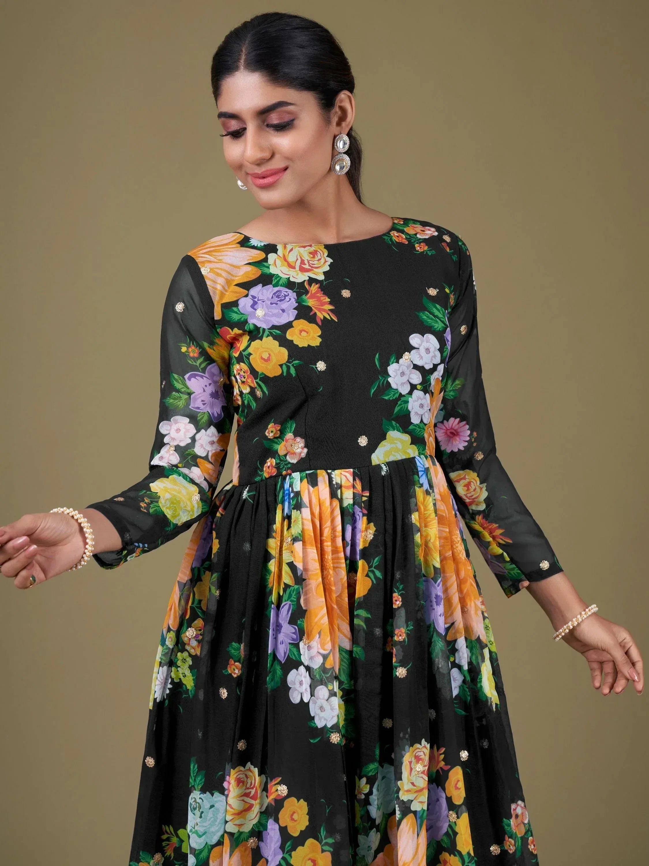 Black floral print ethnic gown with long sleeves and gold embellishments, perfect for Indian occasions.