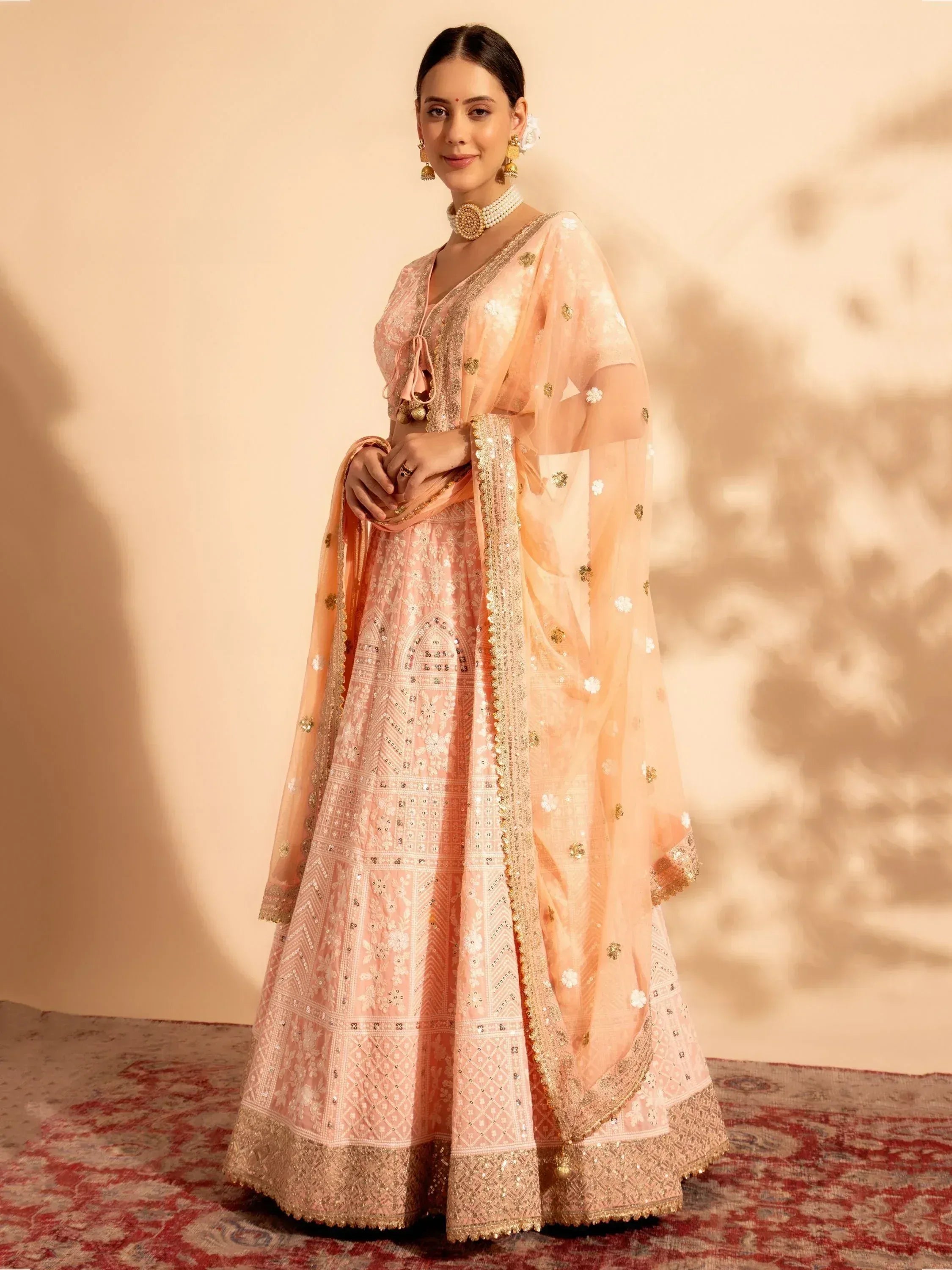Pink embroidered lehenga choli with gold detailing, perfect for Indian weddings and festive occasions