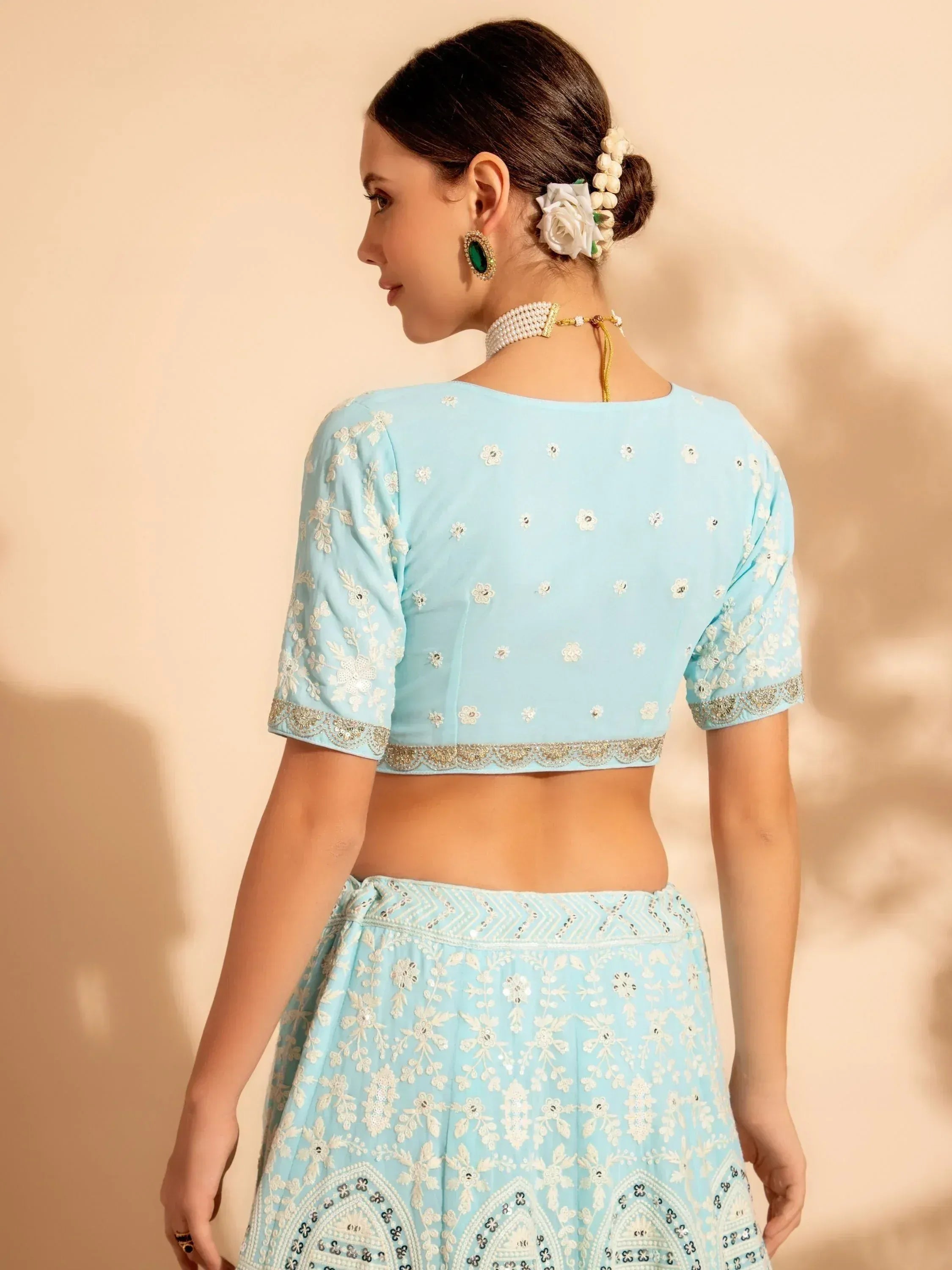 Light blue embroidered lehenga choli with floral detailing, perfect for Indian ethnic wear occasions.