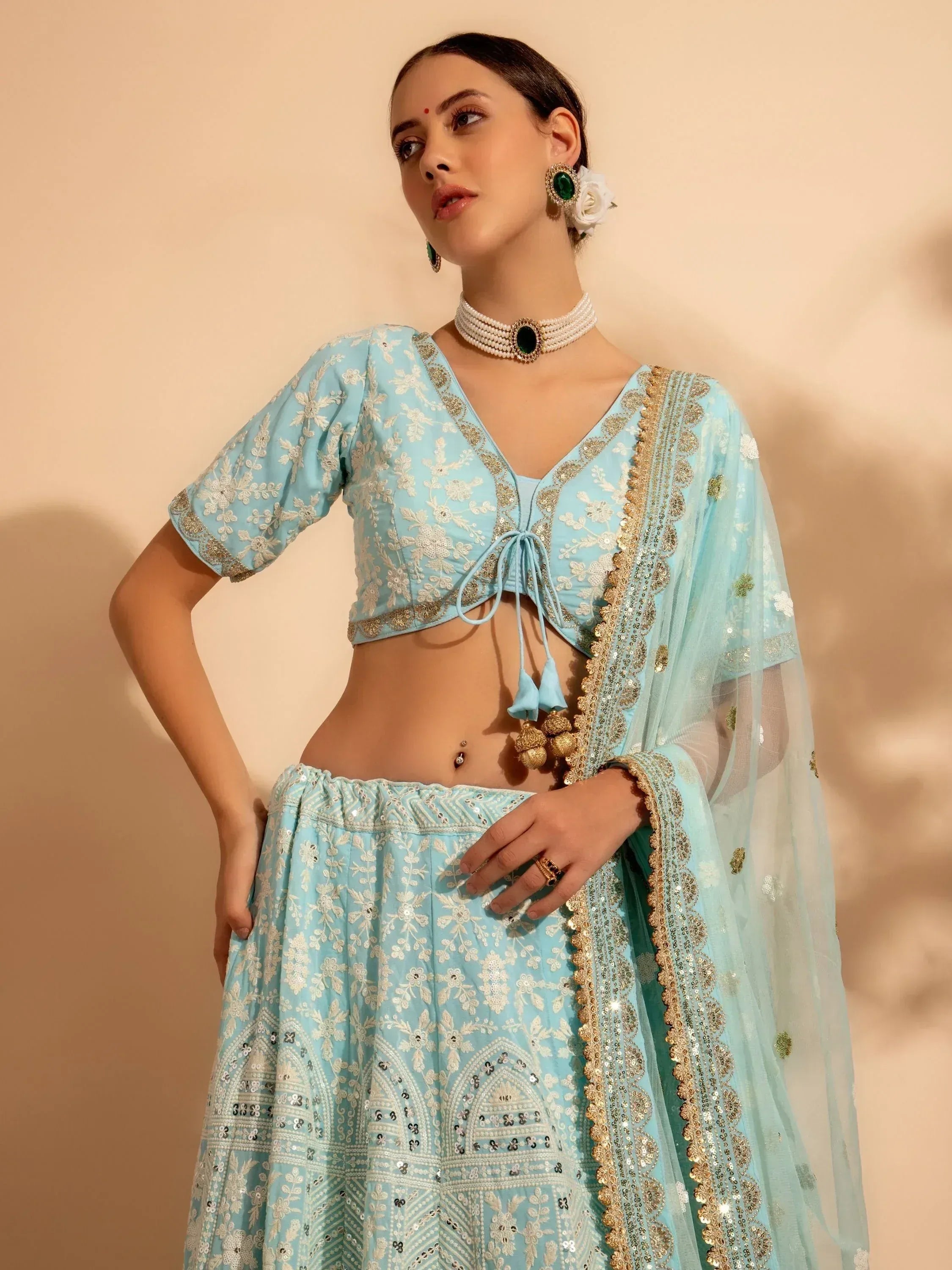 Light blue embroidered lehenga choli with gold detailing and matching dupatta, perfect for Indian ethnic wear occasions.