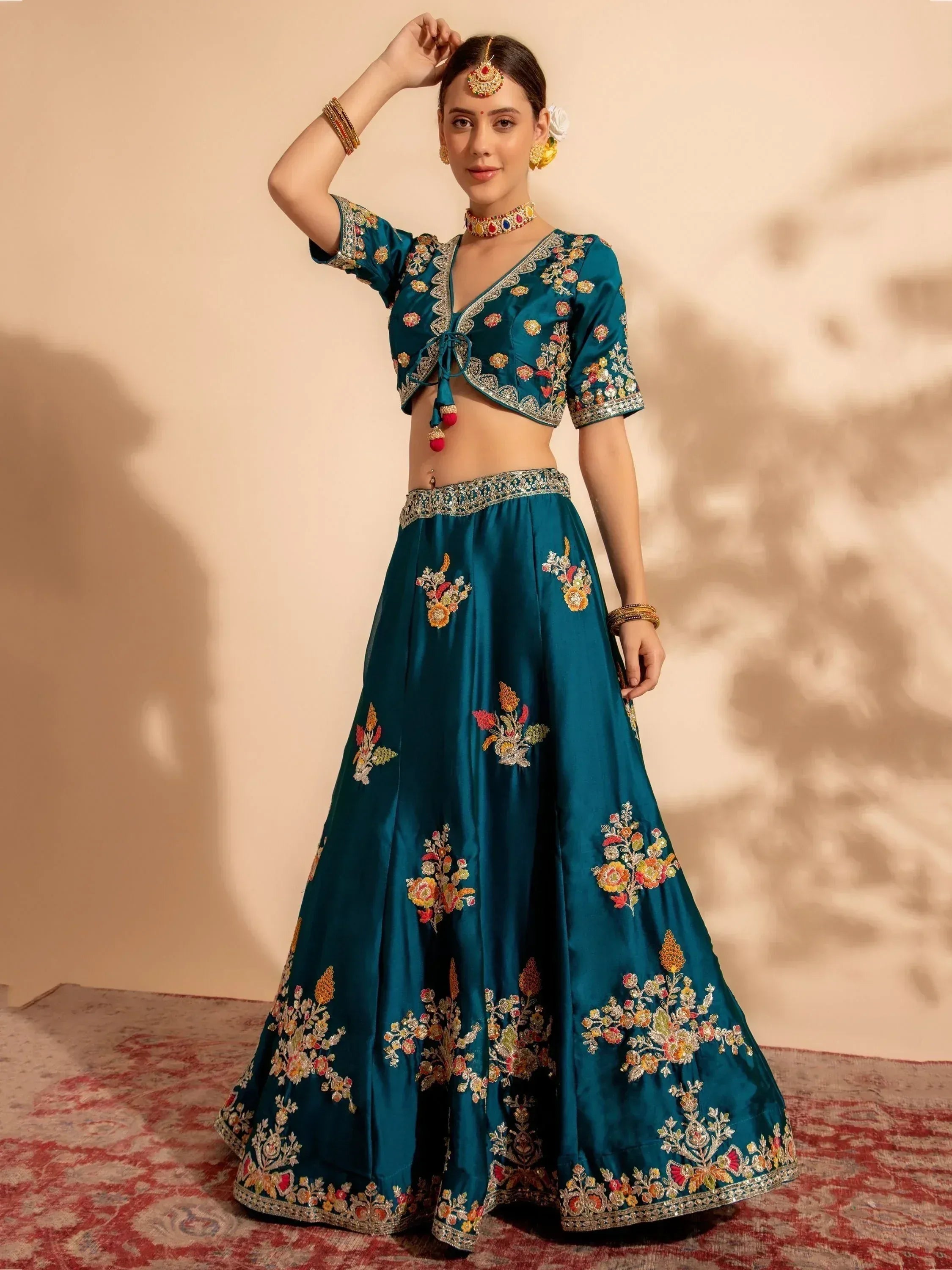 Teal embroidered lehenga choli with floral motifs, perfect for Indian ethnic wear occasions