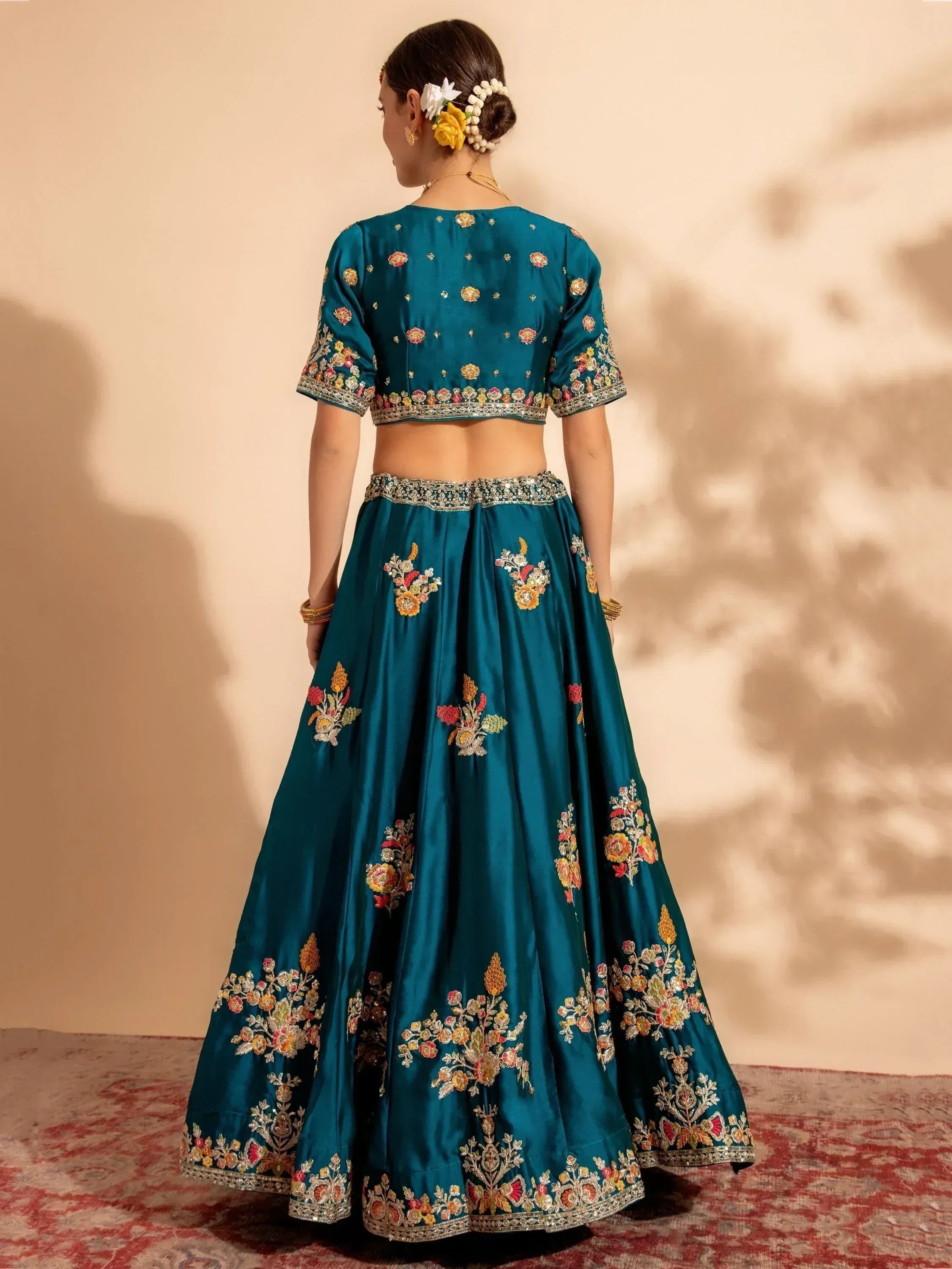 Teal embroidered lehenga choli with floral motifs, perfect for Indian ethnic wear occasions