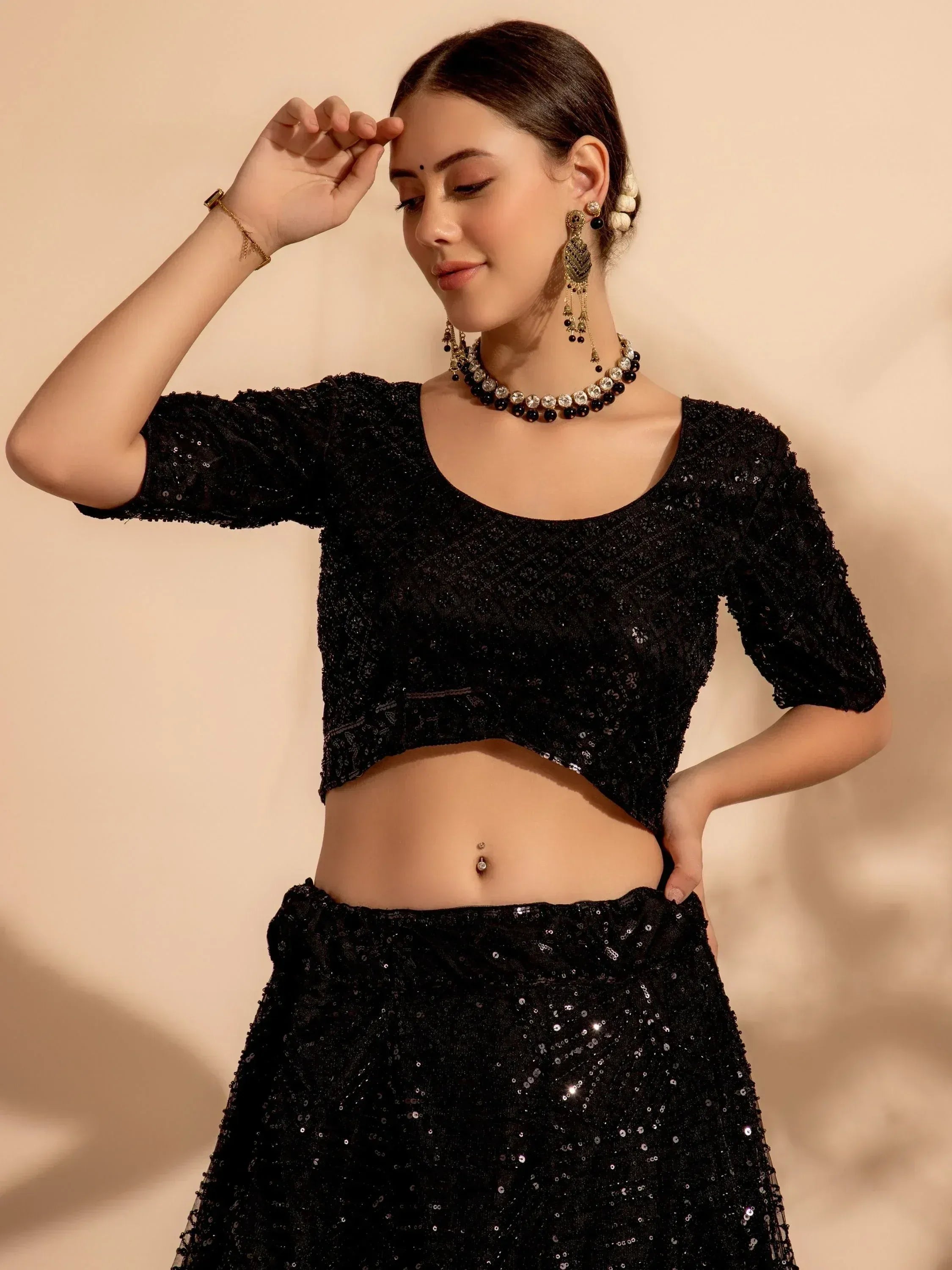 Black sequin lehenga choli with matching jewelry, perfect for Indian ethnic wear occasions.